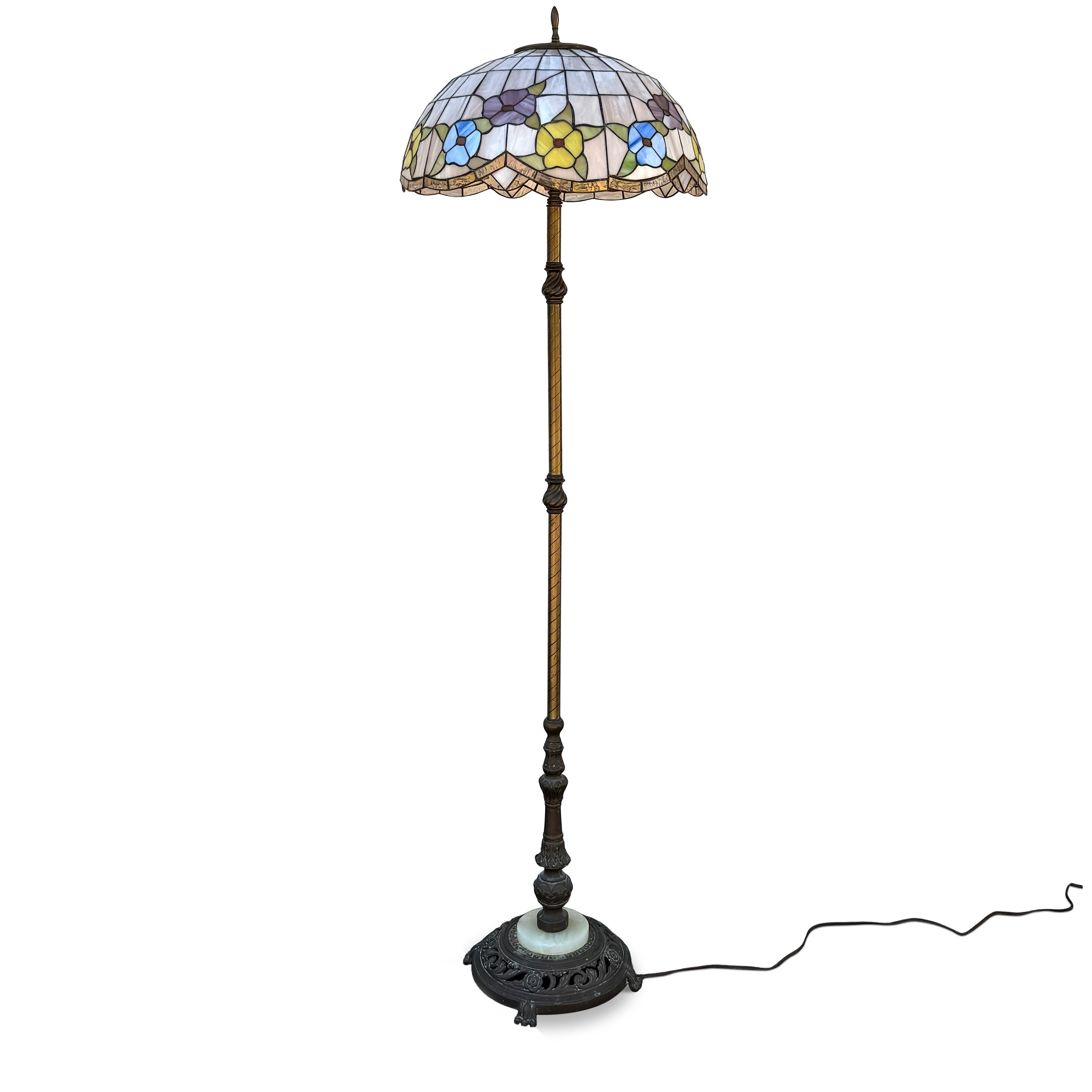 An exquisite antique design (possibly from the 1920s), this lamp provides an outstanding vintage stained glass in the Tiffany Style. The lamp contains a bronze finish base and a quality stained glass shade in the art nouveau style. These
