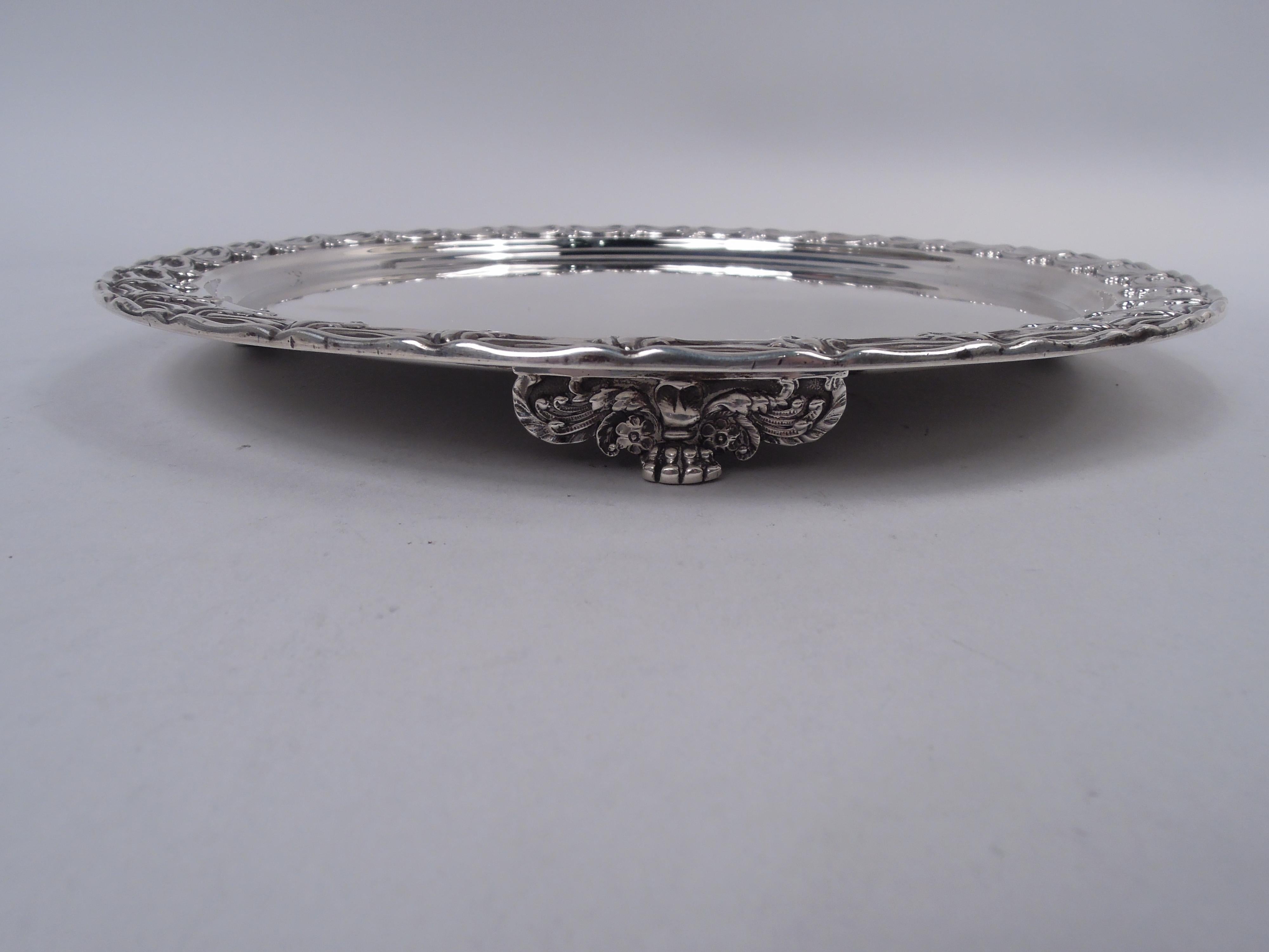 Victorian Classical sterling silver cake plate. Made by Tiffany & Co. in New York, 1879. Round well; rim has applied swag border with pendant leaves. Fully marked including maker’s stamp, pattern no. 5766 (first produced in 1879), and director’s