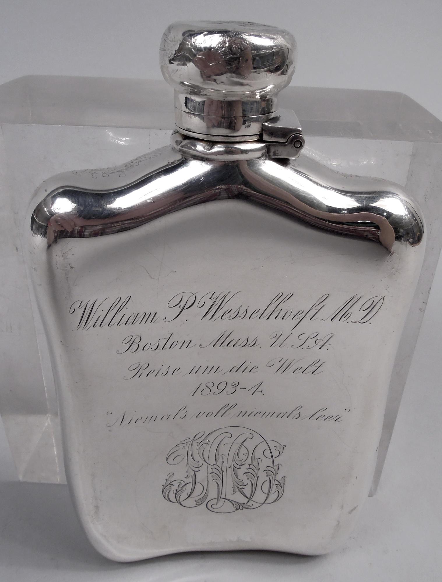 Victorian sterling silver flask. Made by Tiffany & Co. in New York. Rectilinear with wavy top and bottom; cover hinged and cork-lined.

On front acid-etched depiction of a rugby game with the ball carrier breaking through a tackle. Male brawn on the
