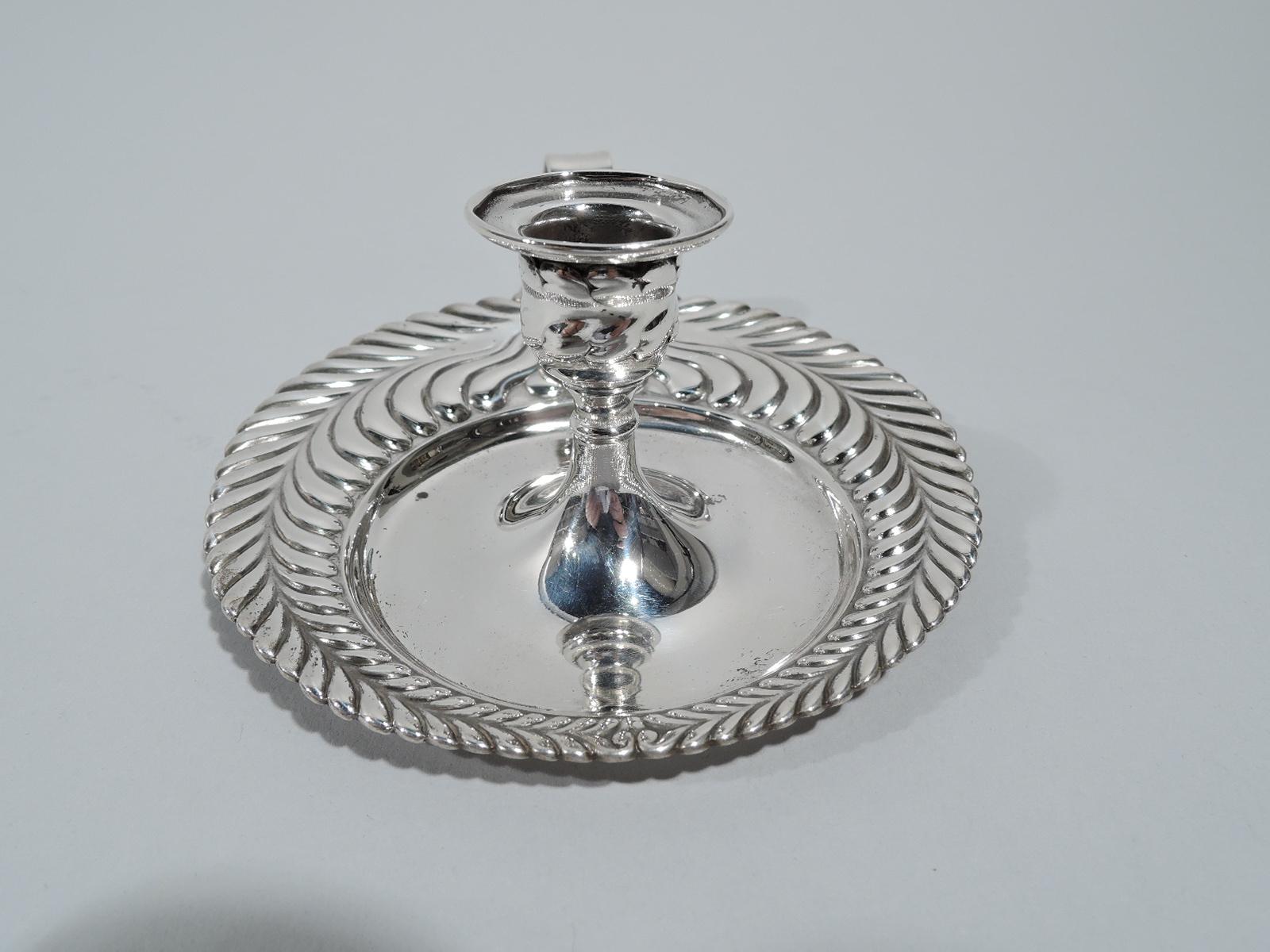 Wave edge sterling silver chamberstick. Made by Tiffany & Co. in New York, ca 1884. Urn socket on raised foot flowing into round stand with loop handle. Graduated and imbricated leaf rim. Fully marked including maker’s stamp, pattern no. 8238 (first