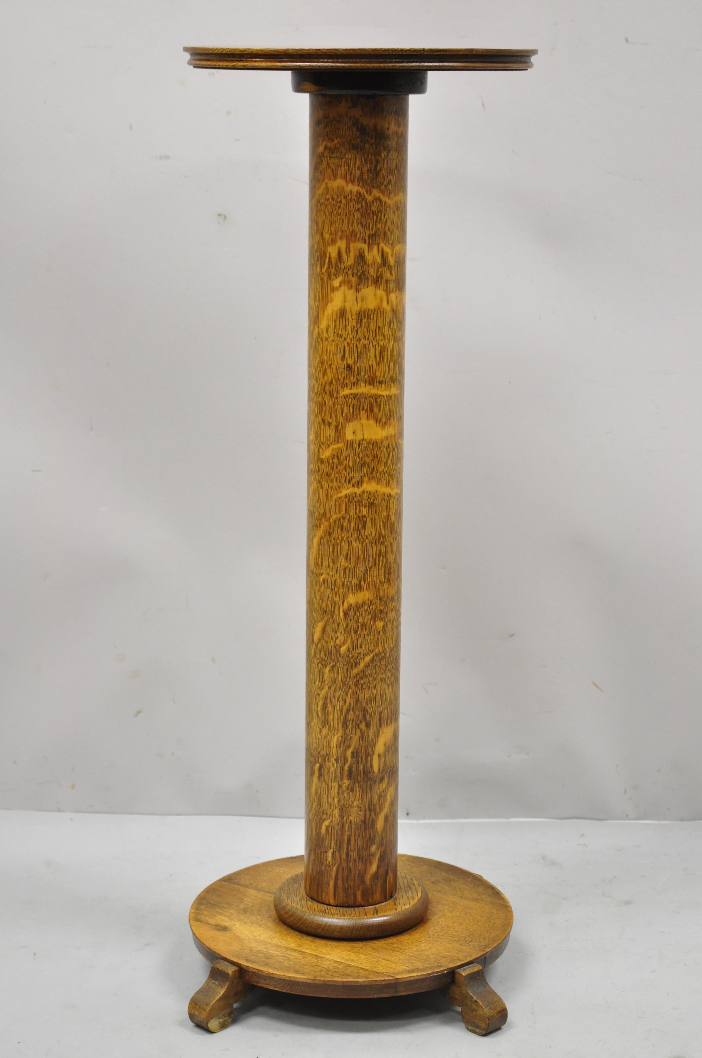 Antique Tiger Oak American Empire round column pedestal plant stand. Item features beautiful tiger oak wood grain, very nice antique item, quality craftsmanship, great style and form. Circa 1900s. Measurements: 36