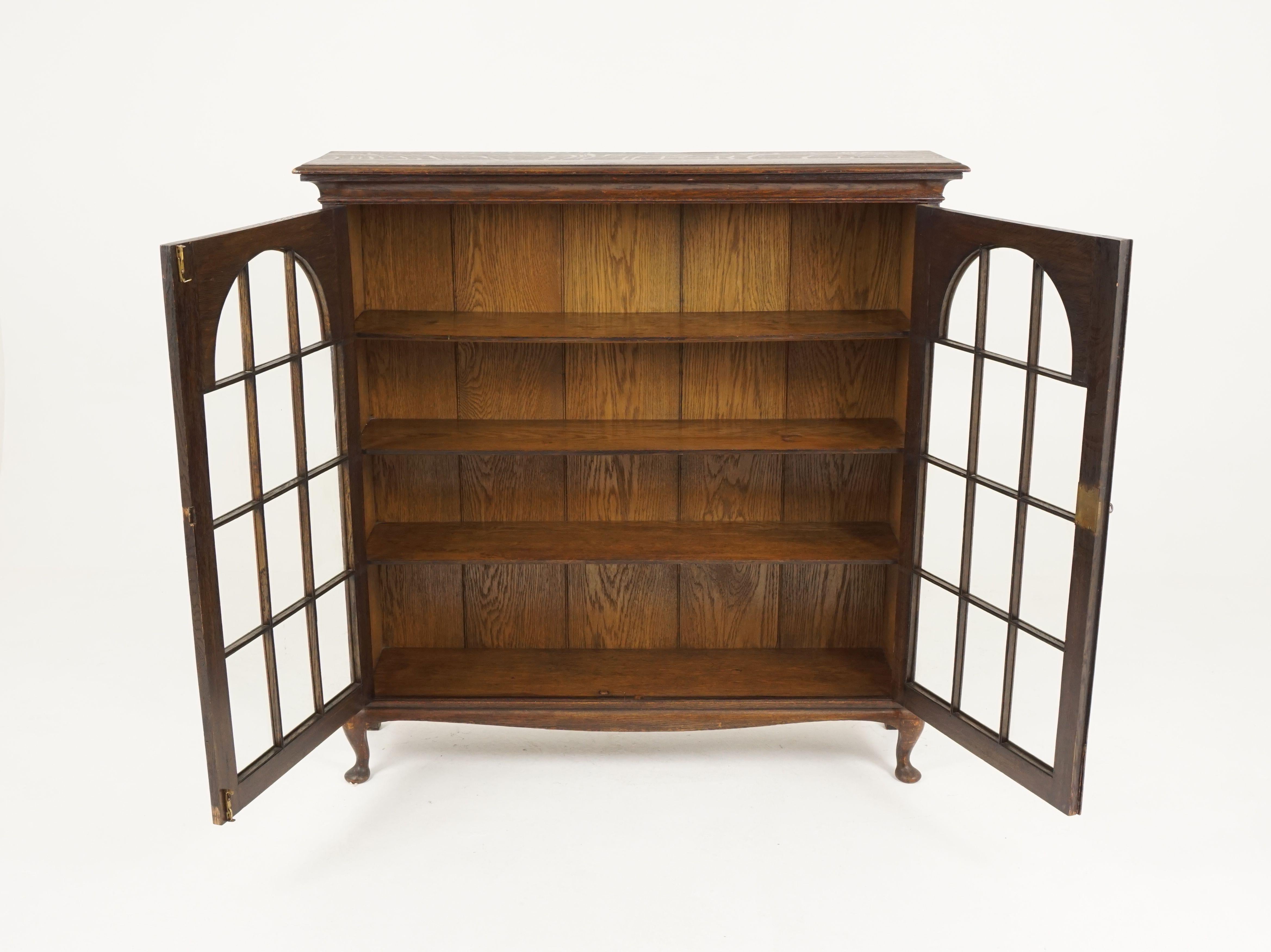 Antique tiger oak bookcase, display cabinet, Scotland, 1920

Scotland, 1920
Solid oak
Original finish
Rectangular moulded top
Pair of thirteen panes dome shaped doors
Open to reveal vertical backboards
Three fixed shields
With working lock
