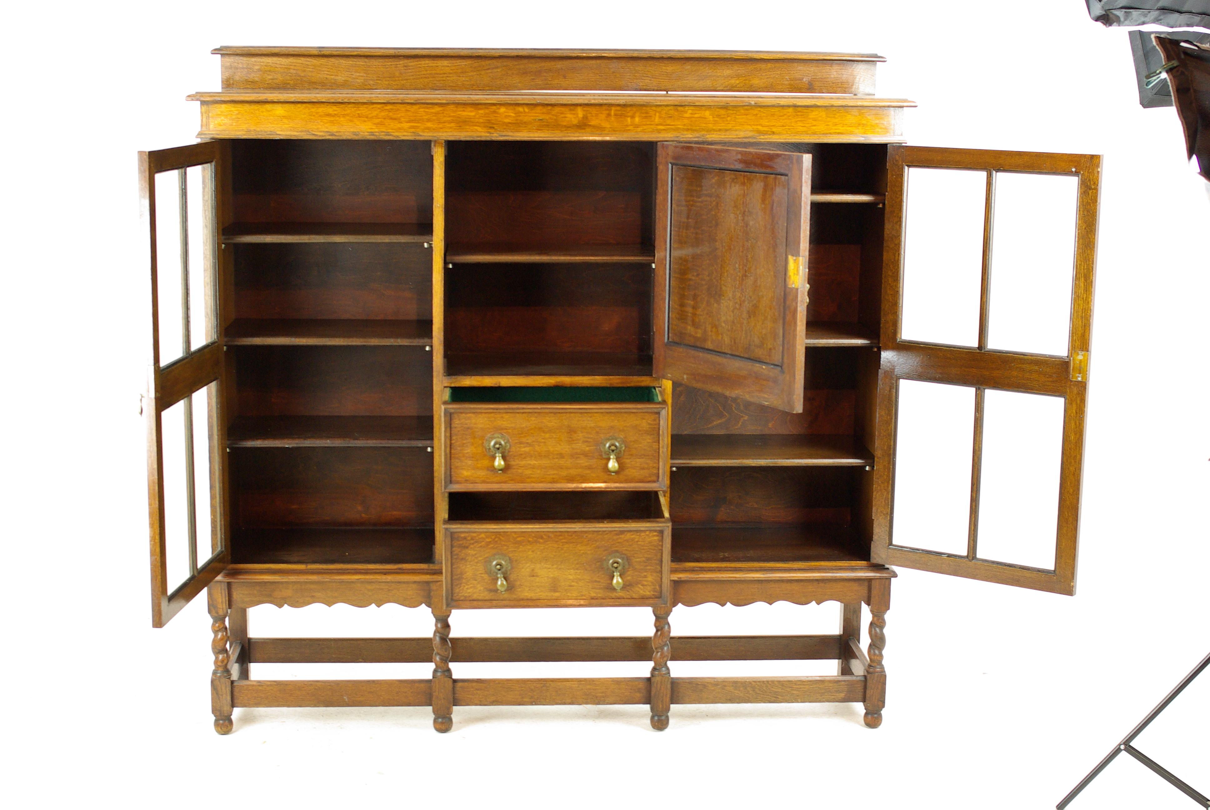 Antique tiger oak bookcase, three-door bookcase, Scotland, 1920, antique furniture, B1236

Scotland, 1920
Moulded ledge back
Rectangular top
Single carved cupboard door with shelf
Pair of dovetailed drawers below with original brass
