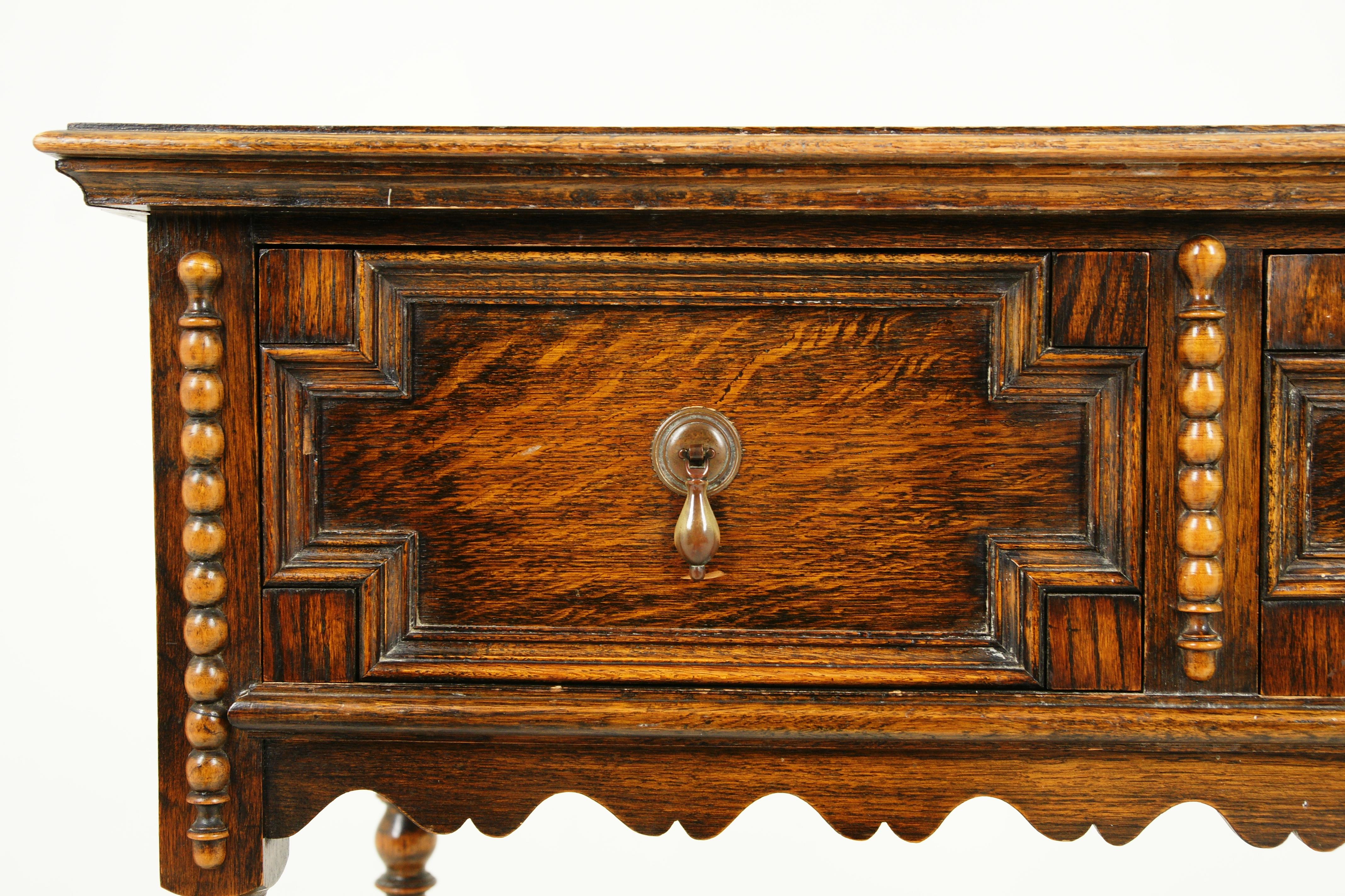 Antique tiger oak hall table, serving table, Scotland 1910, B2341

Scotland 1910
Solid oak
Original finish
Rectangular moulded top
Pair of paneled geometric drawers with original brass handles
Beading on the front sides
Shaped apron