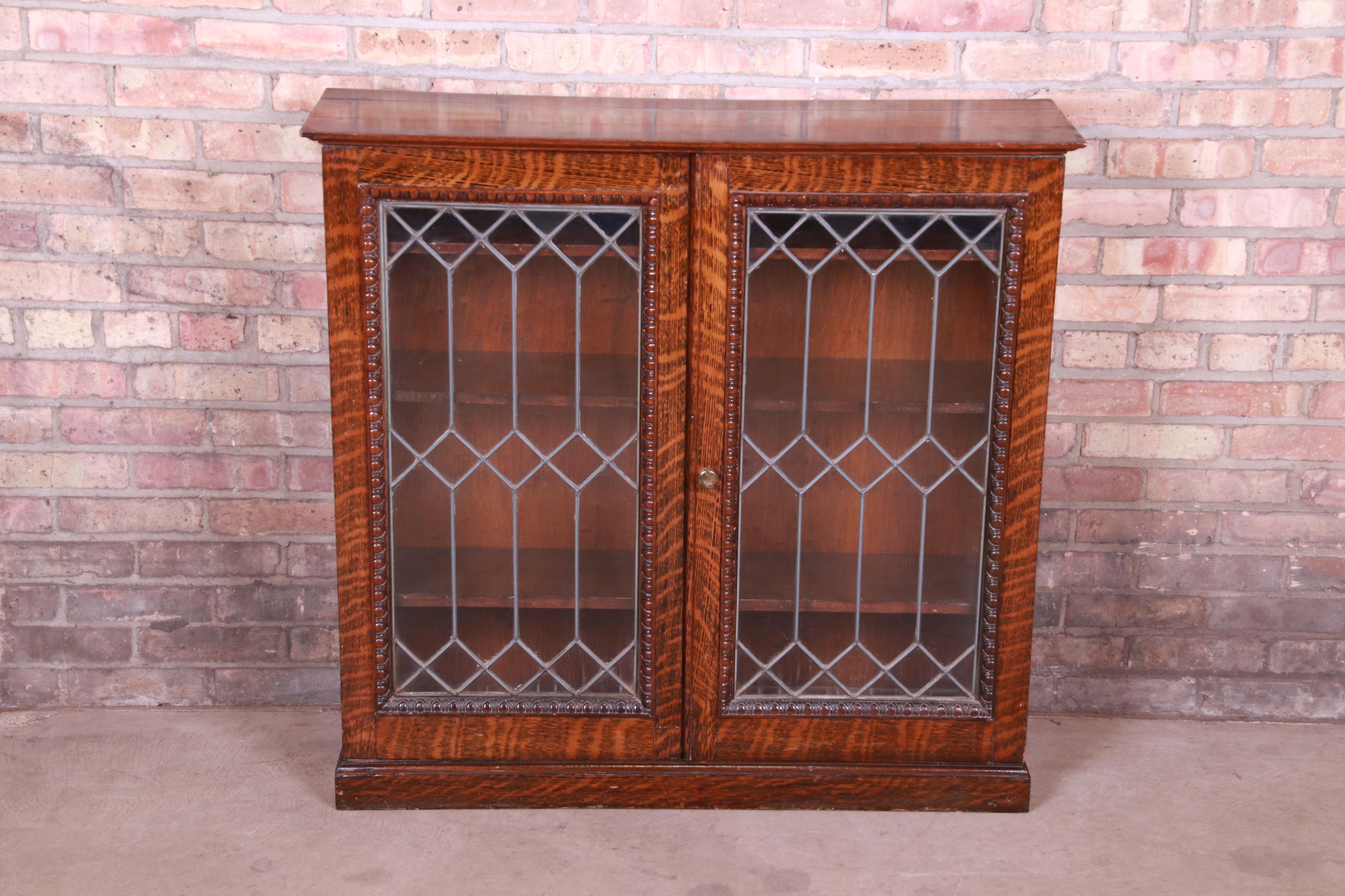A gorgeous antique bookcase

USA, circa 1900

Tiger oak case, with leaded glass doors and brass hardware. Three interior shelves are adjustable.

Measures: 39.13