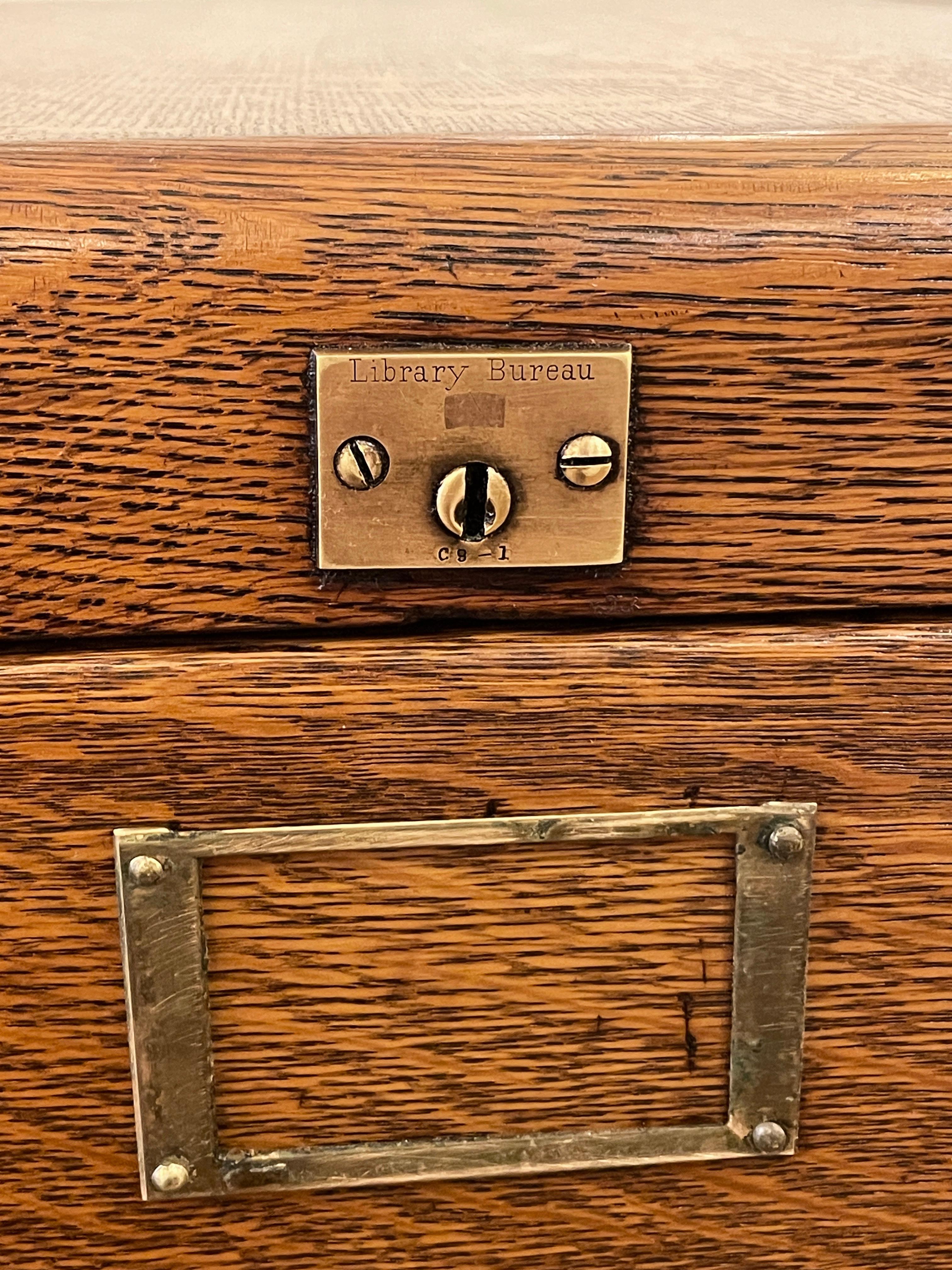 Antique file cabinet with four drawers made of tiger oak. This piece displays a plaque inscribed Library Bureau SoleMakers. It was restored in our shop. One available. Please note, this item is located in one of our NYC locations.