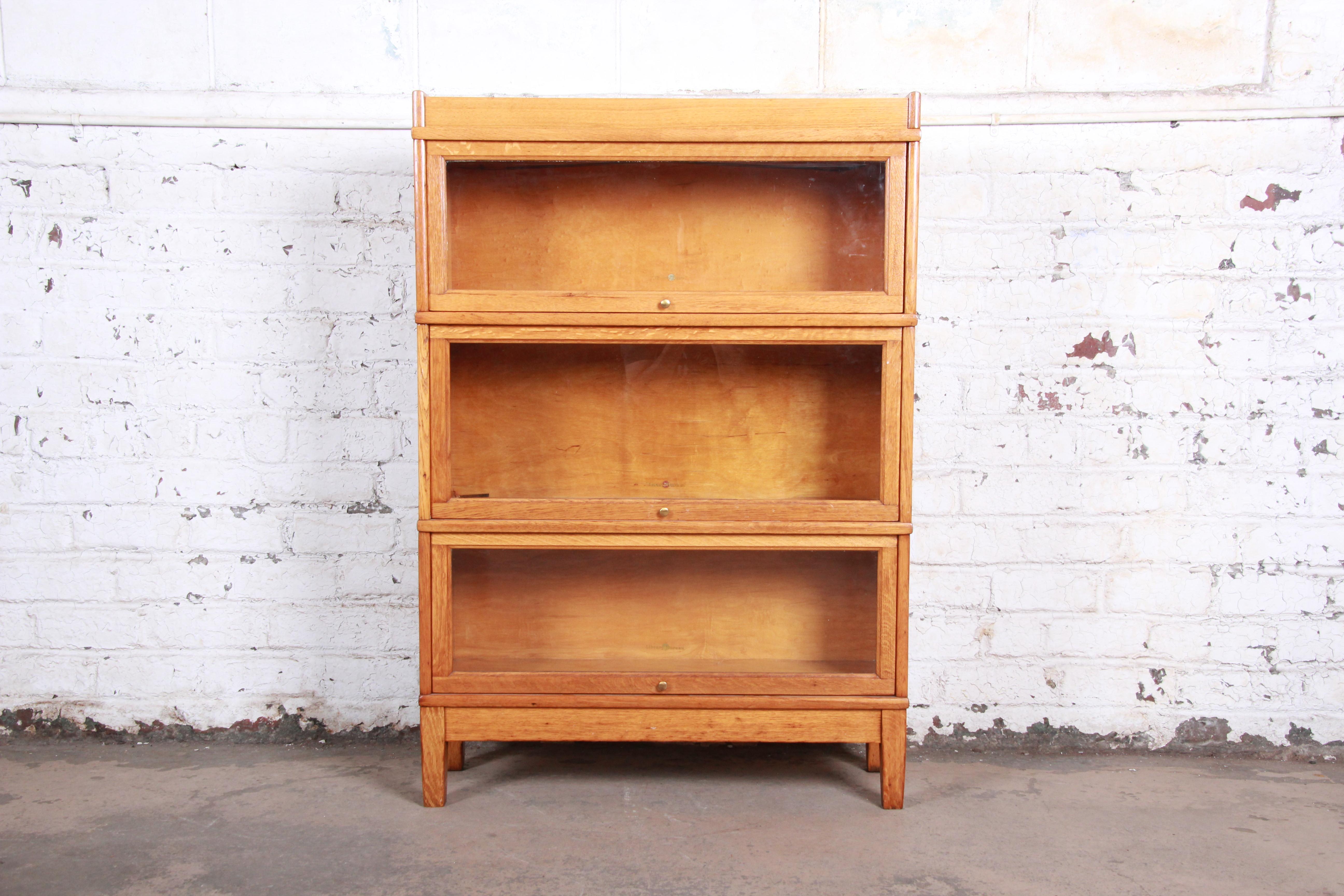 Antique oak three-stack barrister bookcase

Made by Library Bureau

USA, circa 1940s

Tiger oak and brass and glass

Measures: 34.13