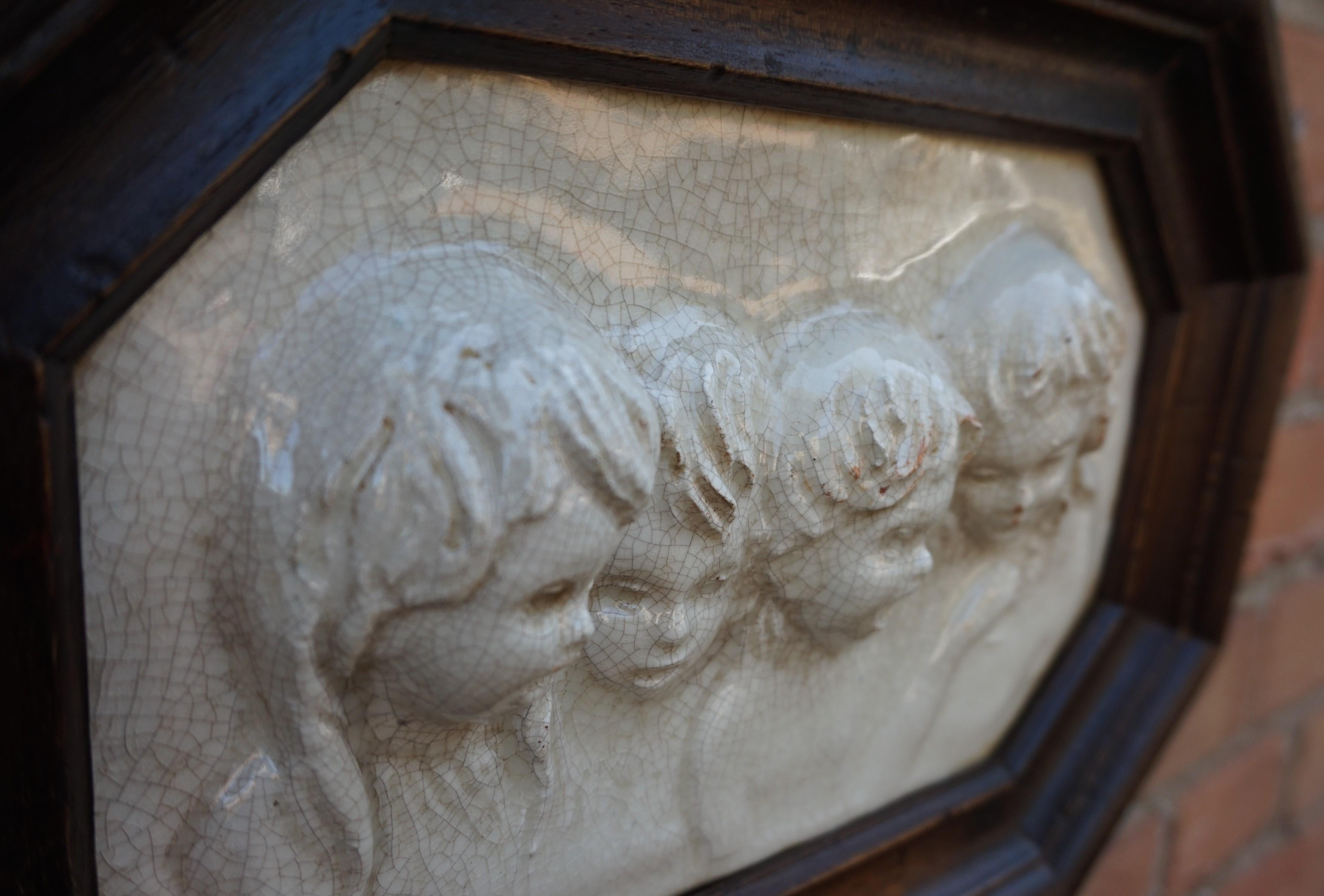 Ceramic Antique Tile in Frame with Devout Singing Angelic Children Sculptures in Relief For Sale