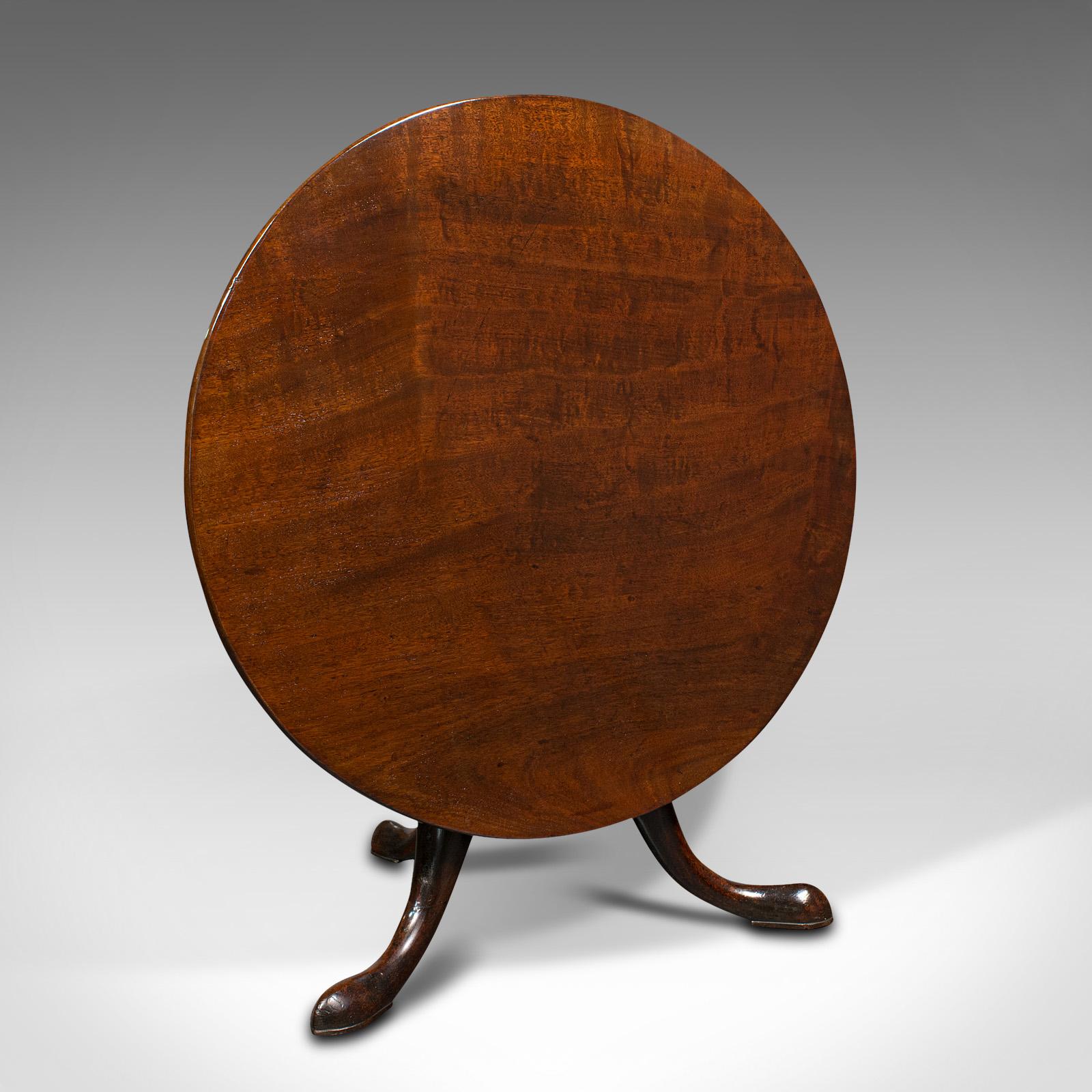 This is an antique tilt top side table. An English, mahogany low wine or afternoon tea table, dating to the early Georgian period, circa 1750.

Beautifully presented Georgian table of low proportion
Displays a desirable aged patina and in good