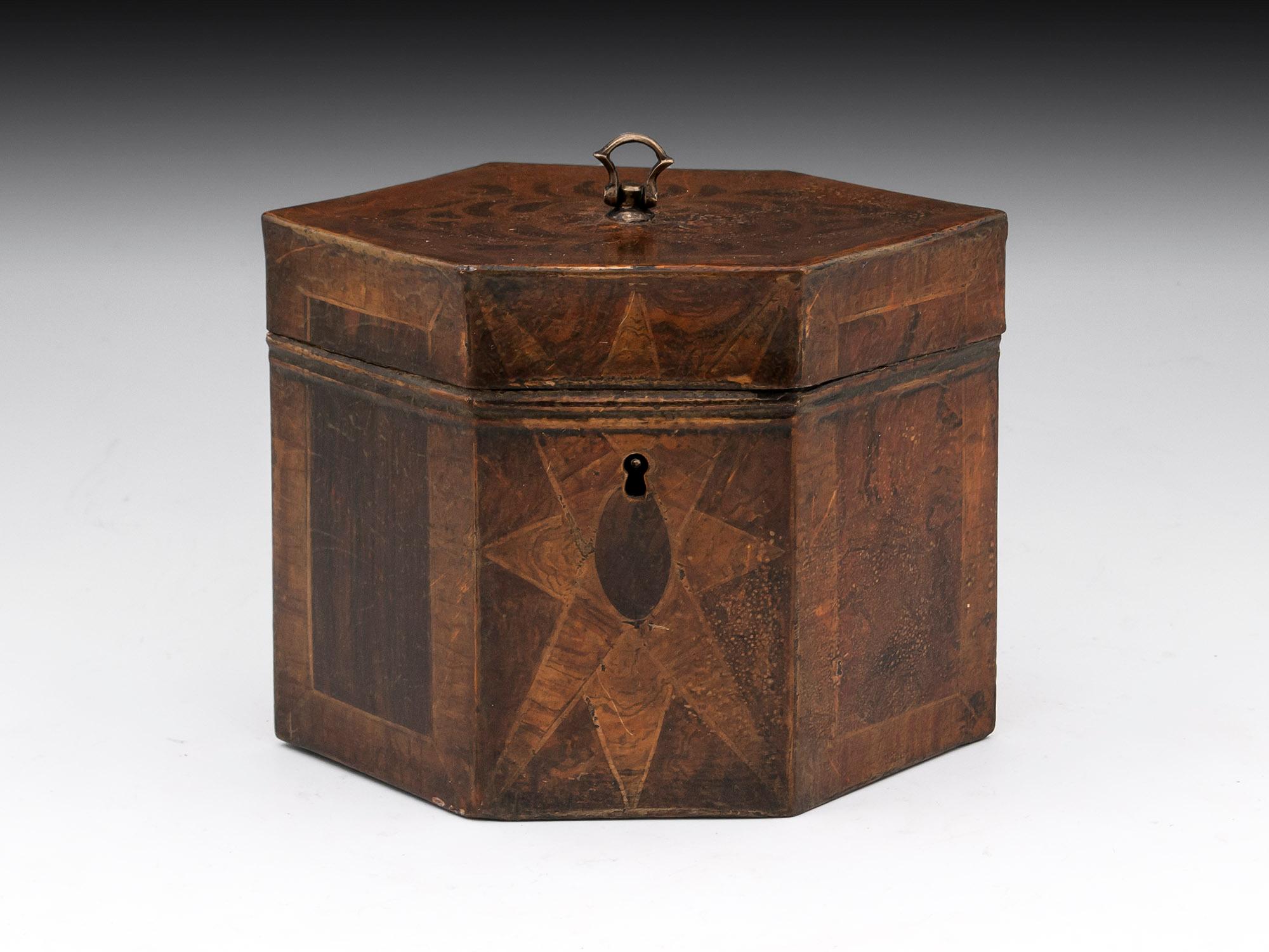 Antique Tinware tea caddy with realistic painted burr veneers, inlays with crossbanding and star motifs. The top has a brass axe handle to help when opening the tea caddy. 

This fabulous twin Tinware tea caddy has comes complete with fully