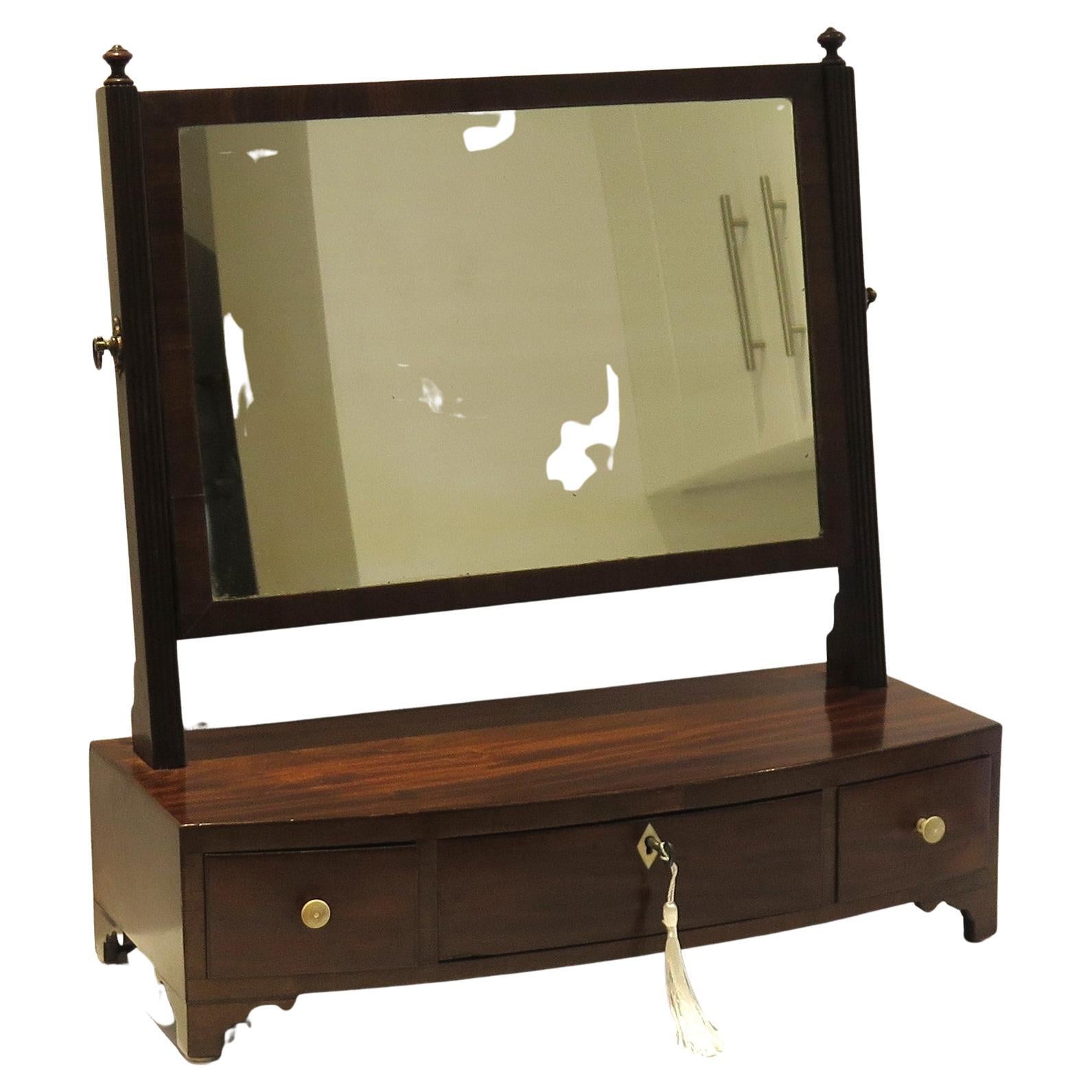 This is a fine quality English Sheraton period antique Toilet Mirror, dating to the late 18th century, late Georgian period, circa 1810.

The mirror is well constructed with many fine features;
 1) Bow fronted on bracket feet, with ivory