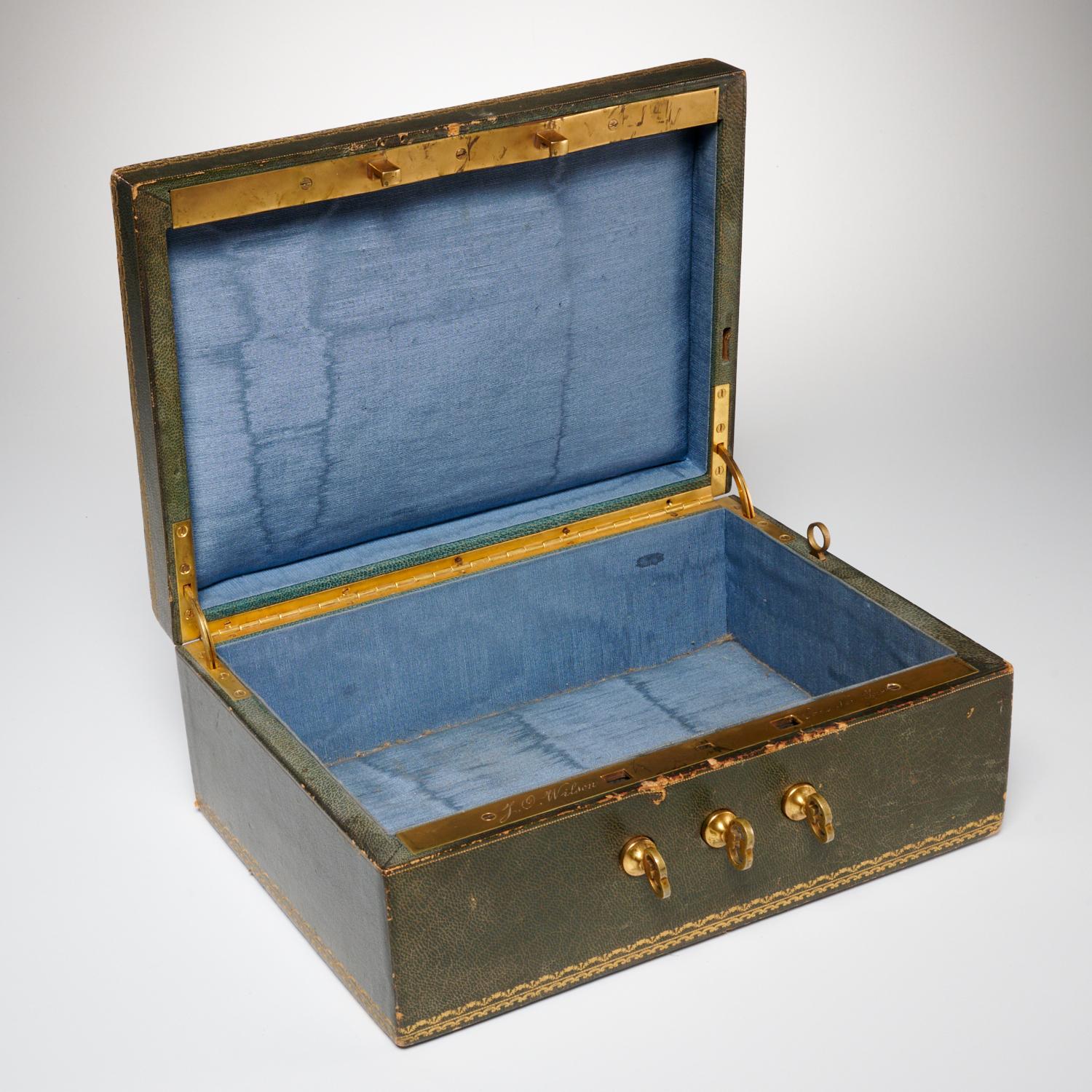 Early 20th c., leather document box with blue silk fabric lined interior, brass mounts and hinges, engraved by retailer 