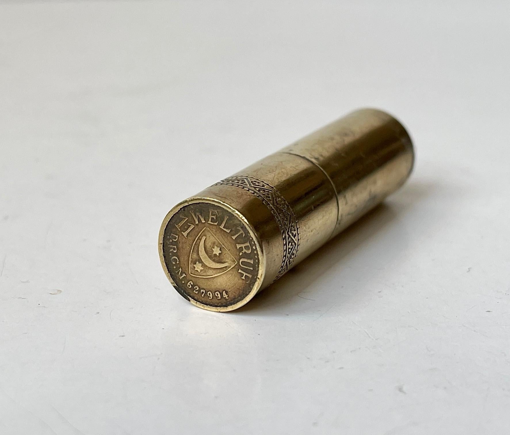 From one of the best makers of straight blade razors comes this small rare cylindrical box/container for toothpicks, matchsticks or pills. It is made from brass entirely and features a beaded decoration and custom made 'faux' coins to the ends with