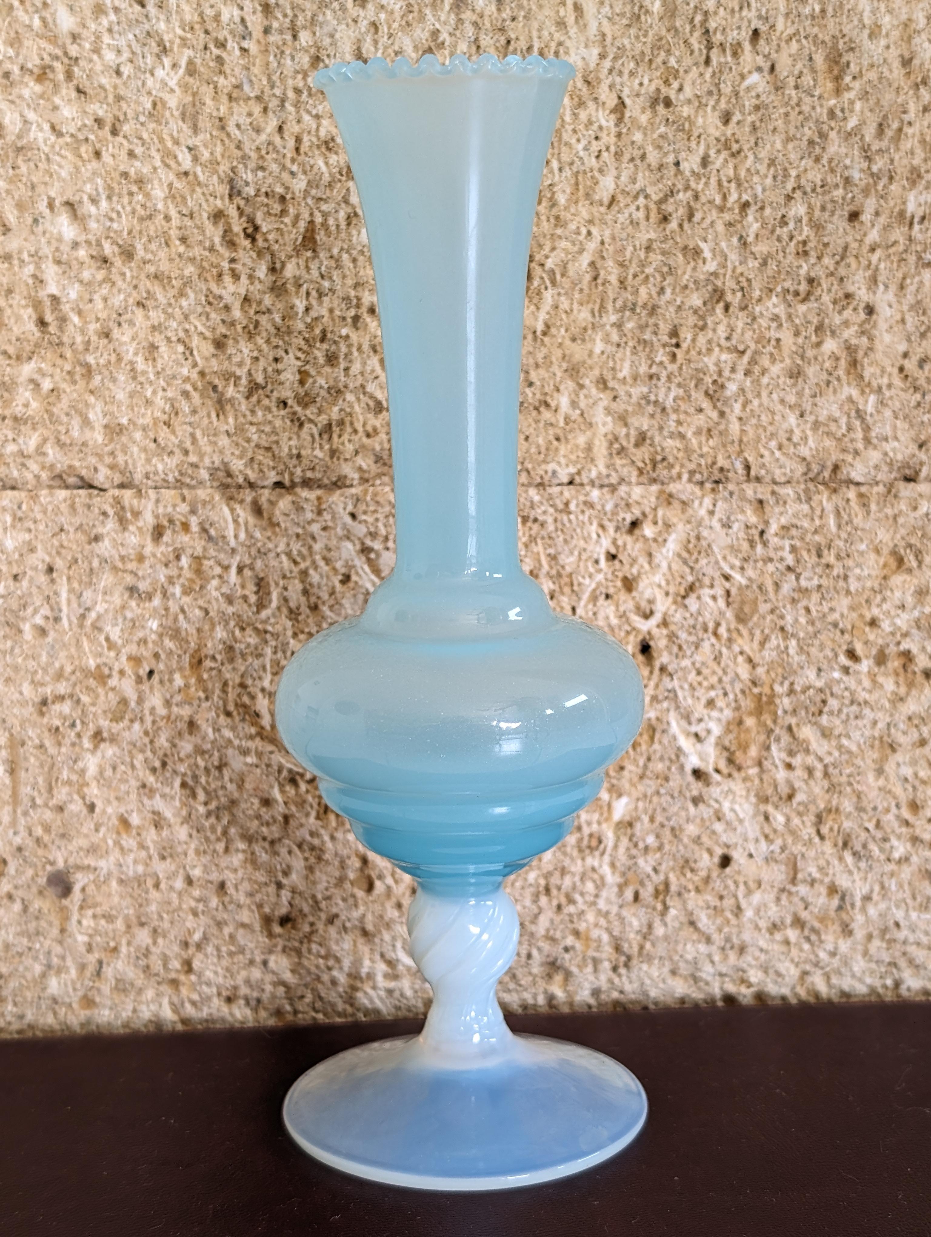 Introducing an exquisite antique turquoise mid-20th century opaline vase, a captivating piece that combines timeless elegance with vintage charm. This stunning vase features the vibrant and serene hues of turquoise opaline glass, celebrated for its