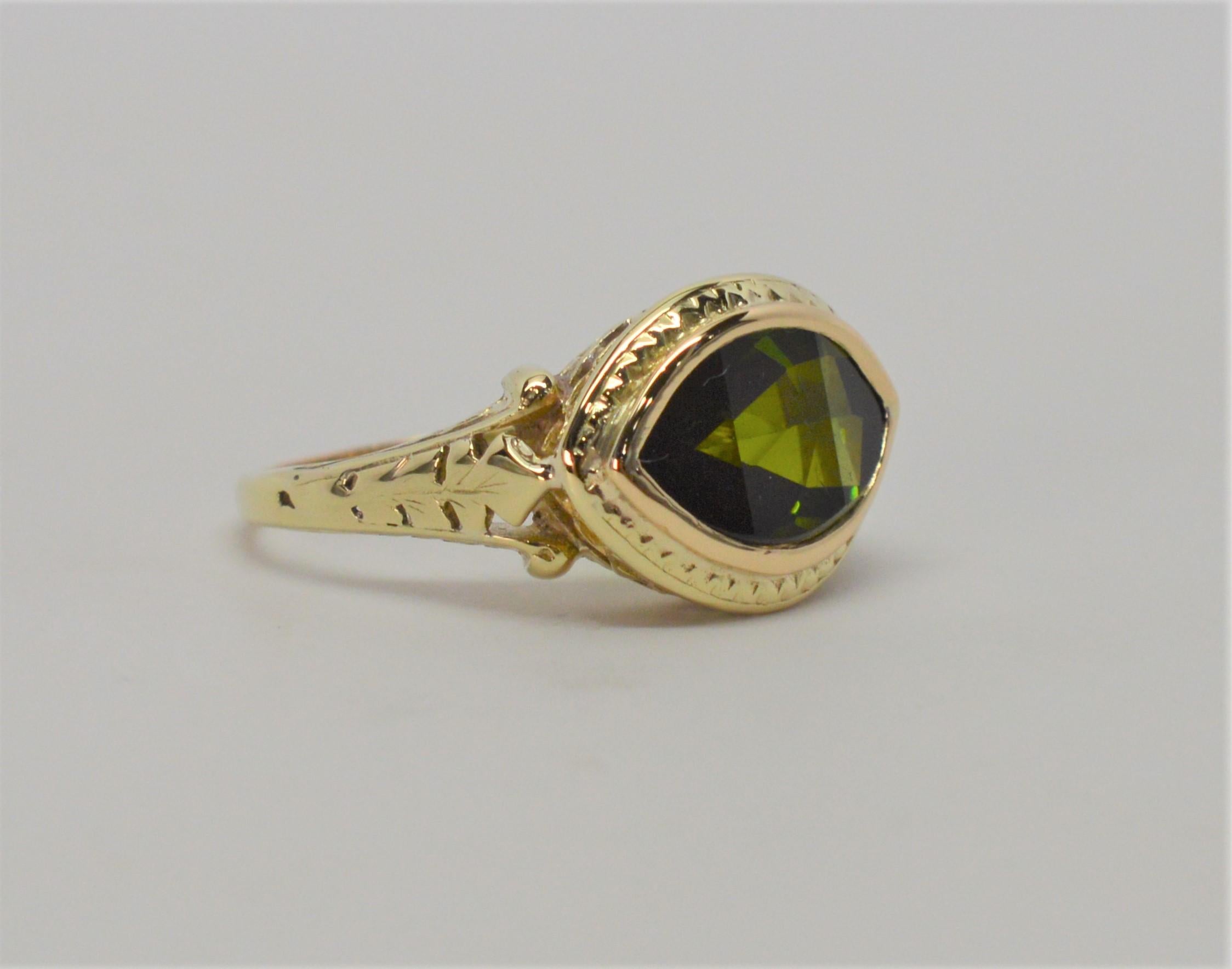A fine tourmaline gemstone sits pretty in this antique 14 karat yellow gold ring setting. In size 6, with a natural 2.5 carat vibrant green tourmaline
faucet-cut marquise gemstone. In gift box.