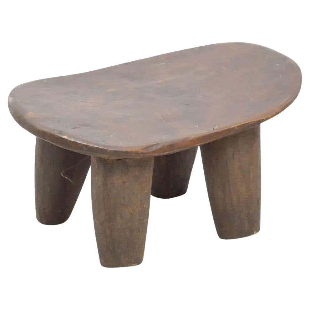 Antique traditional African wood stool, circa 1930
By unknown manufacturer from Africa.

In original condition, with some visible signs of previous use and age, preserving a beautiful patina.

Materials:
Wood 

Dimensions:
D 26 cm x W 46 cm