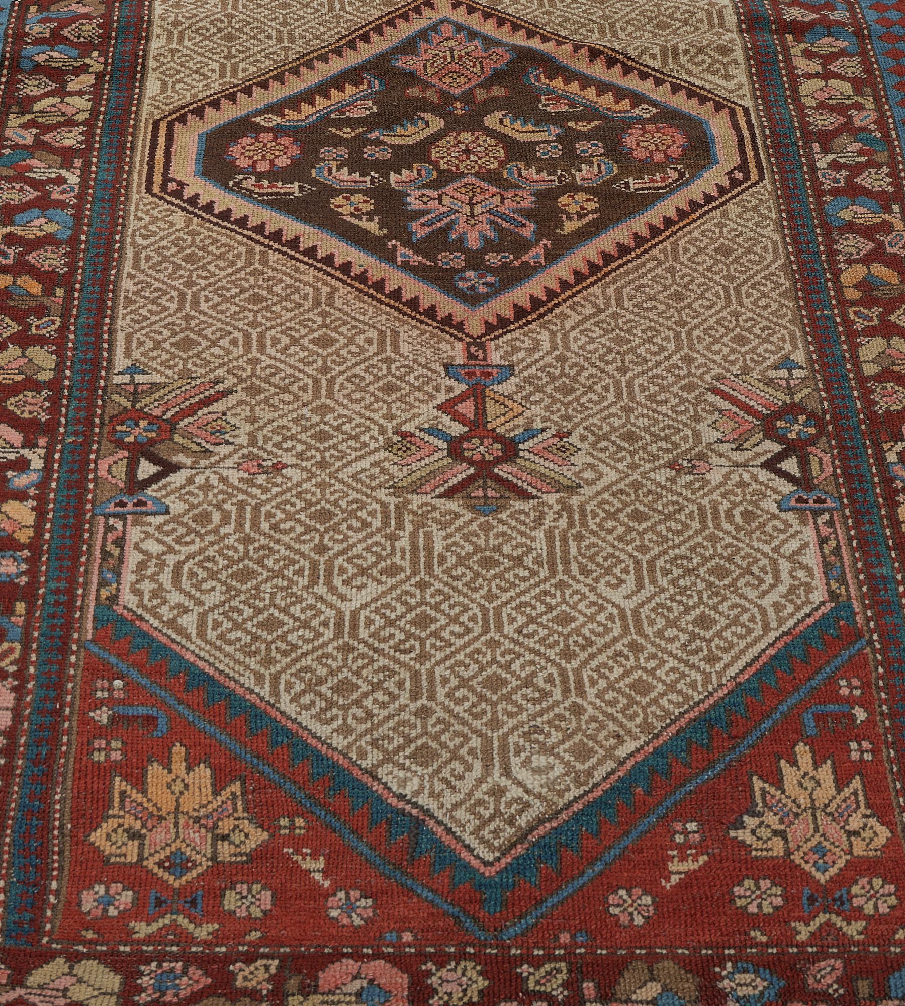 This antique Serab runner has a camel-brown field with a diagonal rows of buff-brown linked lattice enclosing a central small lozenge issuing hooked vine around a central chocolate-brown lozenge medallion containing angular serrated leaves and