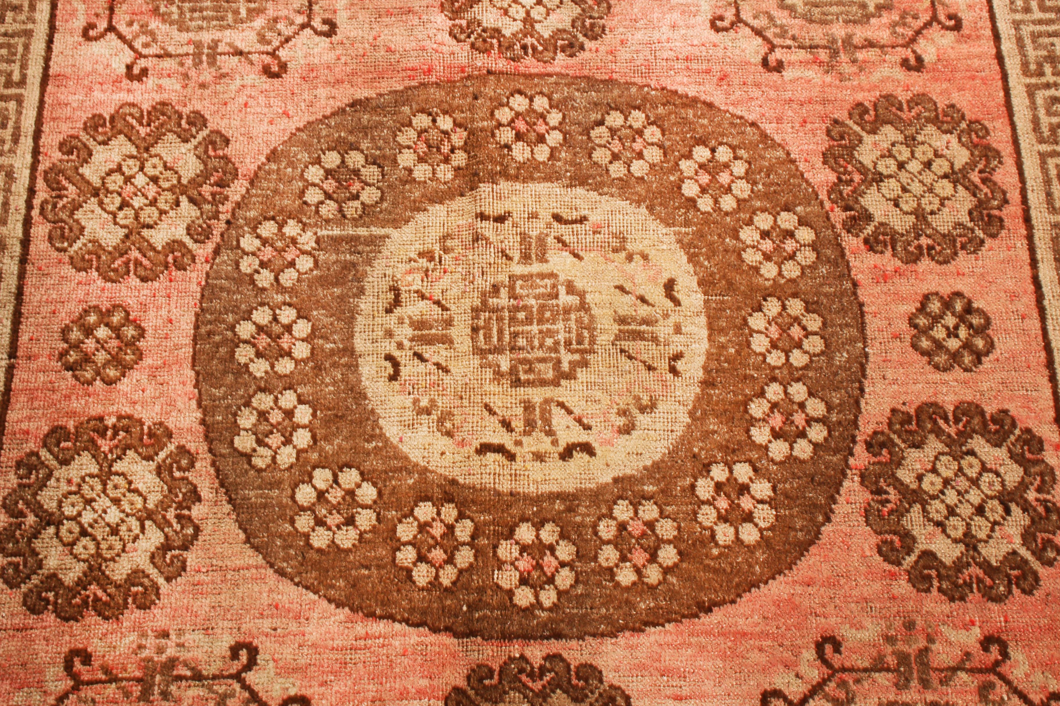 Originating from East Turkestan between 1920-1940, this semi-antique Khotan wool rug from Rug & Kilim employs traditional imagery in unique, pristine colorways. Handmade in high-quality wool, the medallion style field design depicts an ornate