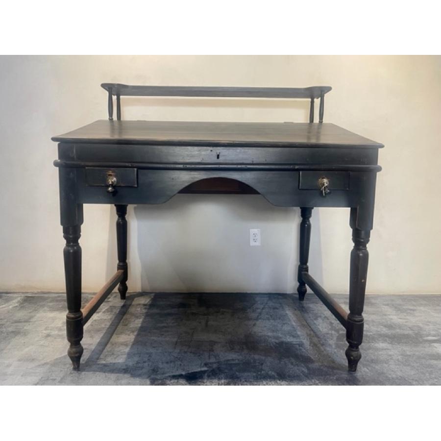 Antique Traditional Secretary Wood Desk with Shelf

The secretary desk with shelf originates from France. The wood desk has a warm, worn black finish with drawers on the front and back and a display shelf on top. The front drawers have brass pendant