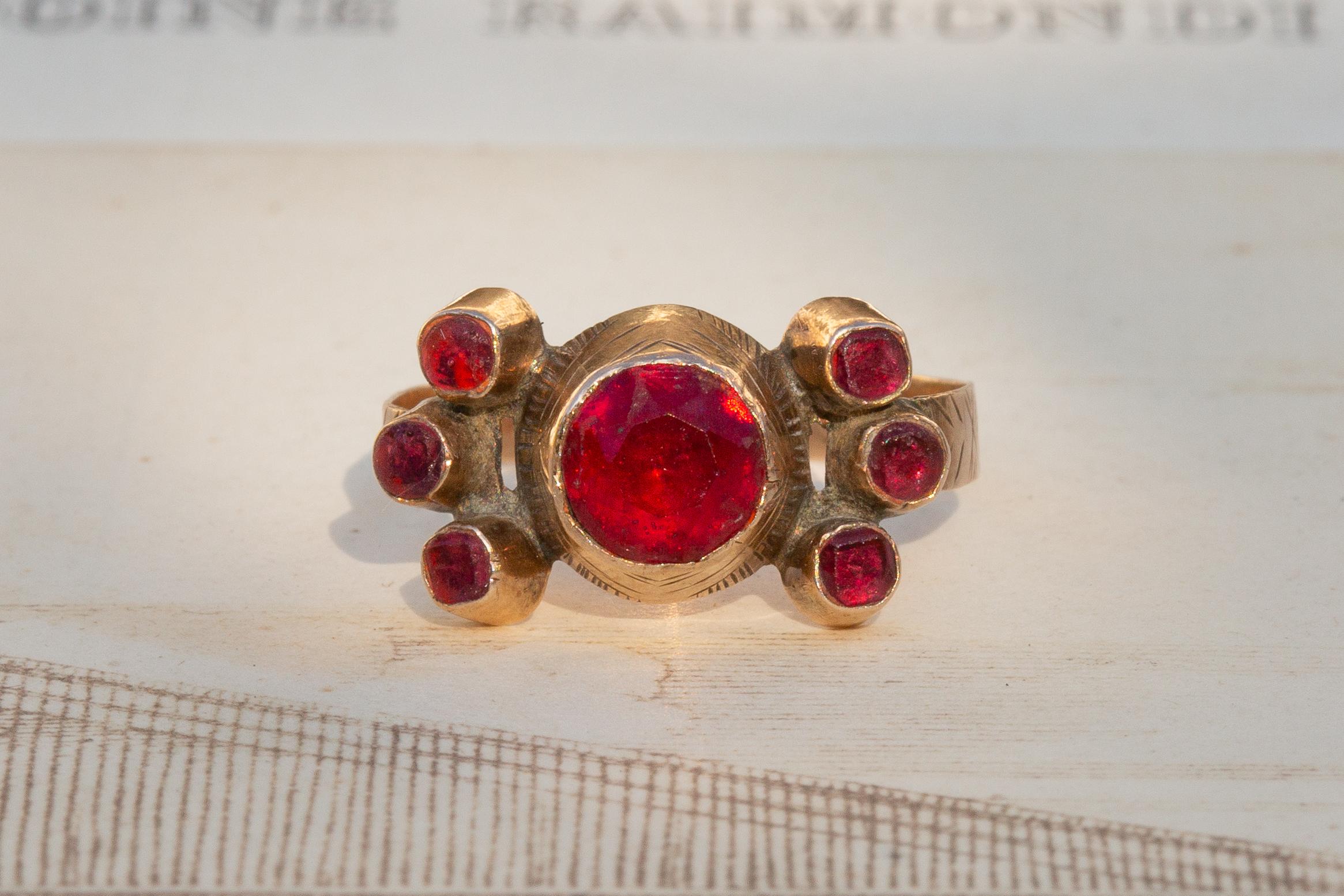 This scarce Sicilian gold cluster ring dates from the late 18th to early 19th century. Known regionally as ‘a fiocco’ rings (bow rings), these traditional pieces were originally gifted as engagement or wedding rings.

This particular example is set