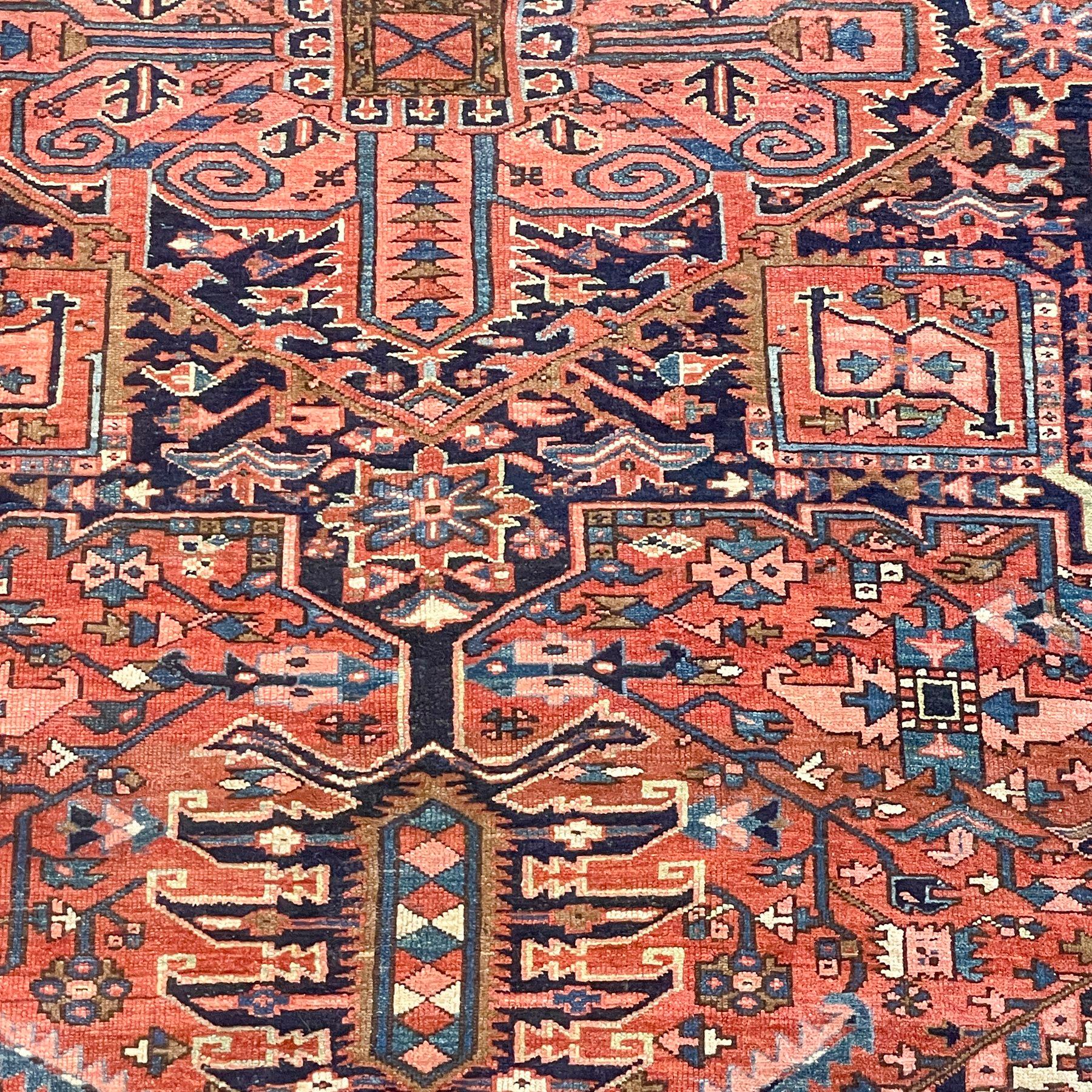 This traditional antique Turkish area rug features rich shades of red, blue, and beige, creating a timeless medallion design. Measuring 7' 10' W x 11' 2