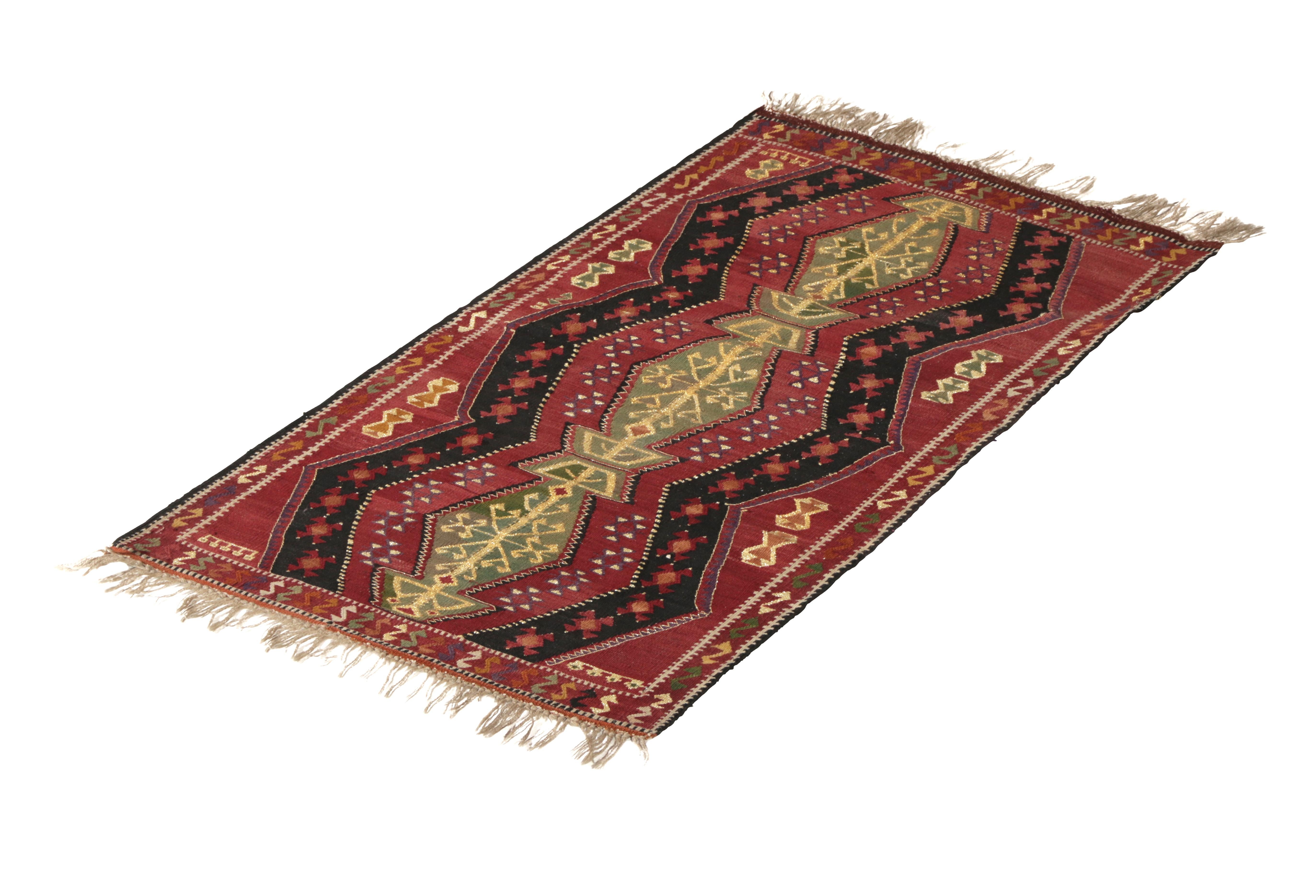 Originating from Turkey in 1910, this antique traditional wool Kilim rug features a variety of both celebratory and protective magical symbols from antiquity. Flat-woven in durable wool, the shook symbols of the wrapping border represent the tools