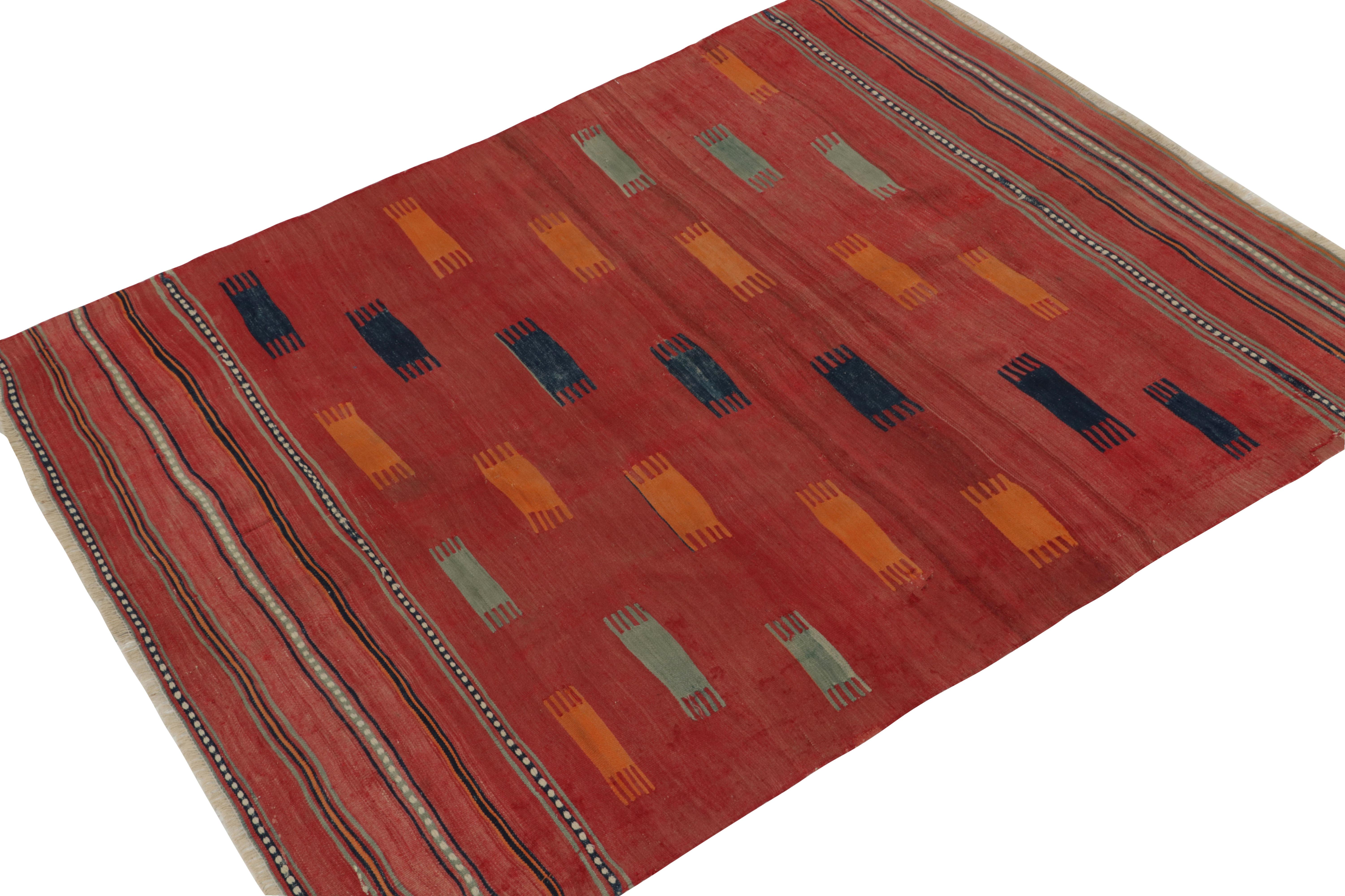 Connoting the celebrated tribal style, this 5x7 kilim rug hails from a special new curation of antique flat weaves. This flatweave from Turkey features a pleasing pattern & striations in a soft sense of warmth in red with a beautiful play of blue,