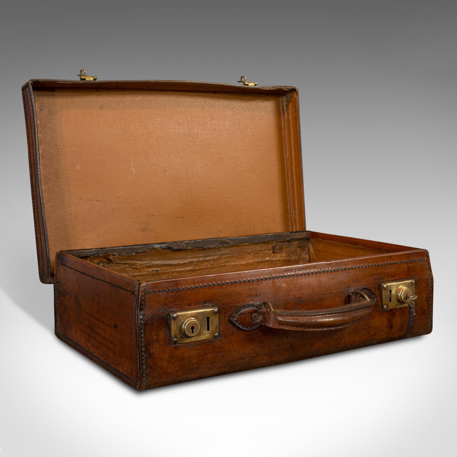 This is an antique travel case. An English, leather banker's suitcase, dating to the Edwardian period, circa 1910.

Carry documents in style
Displays a desirable aged patina
Leather shows appealing russet hues

Generously sized, comfortable