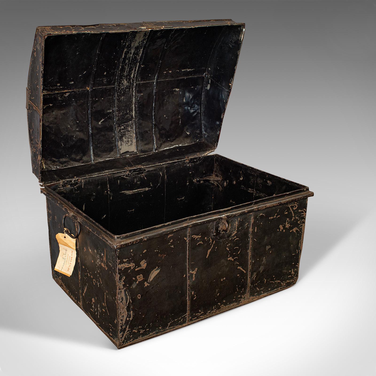 This is an antique travel trunk. An English, tin shipping chest in the name of T.B. Wildman, vice consulate for Great Britain in Punta Arenas, Chile and dating to the early 20th century, circa 1919.

Of historical interest and appeal
Displays a