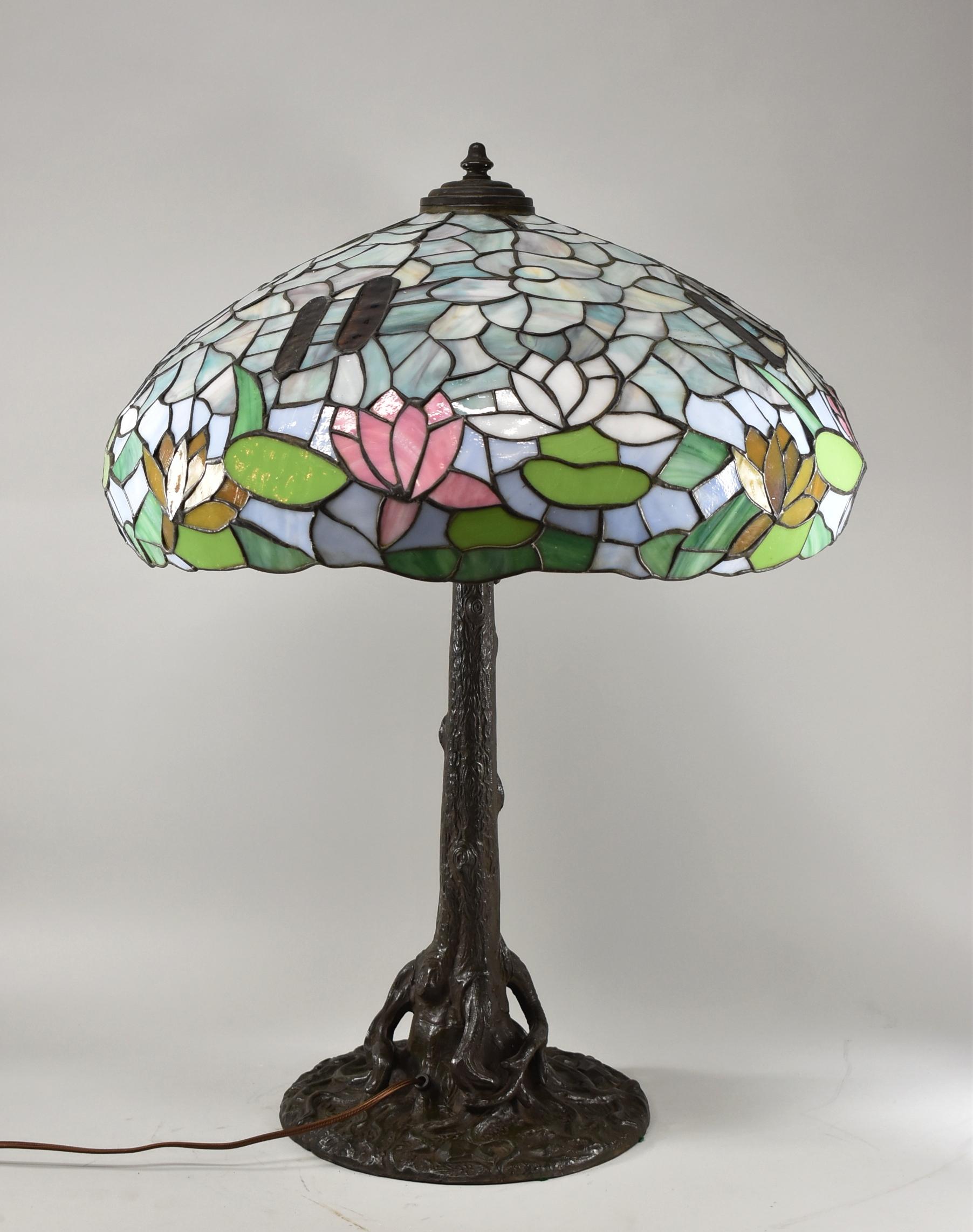 Antique tree trunk base with stained glass Wilkinson shade cattails & water lilies. Acorn pull chains. Three sockets. Shade has a photo in Mosaic Shades Volume II by Paul Christ book.