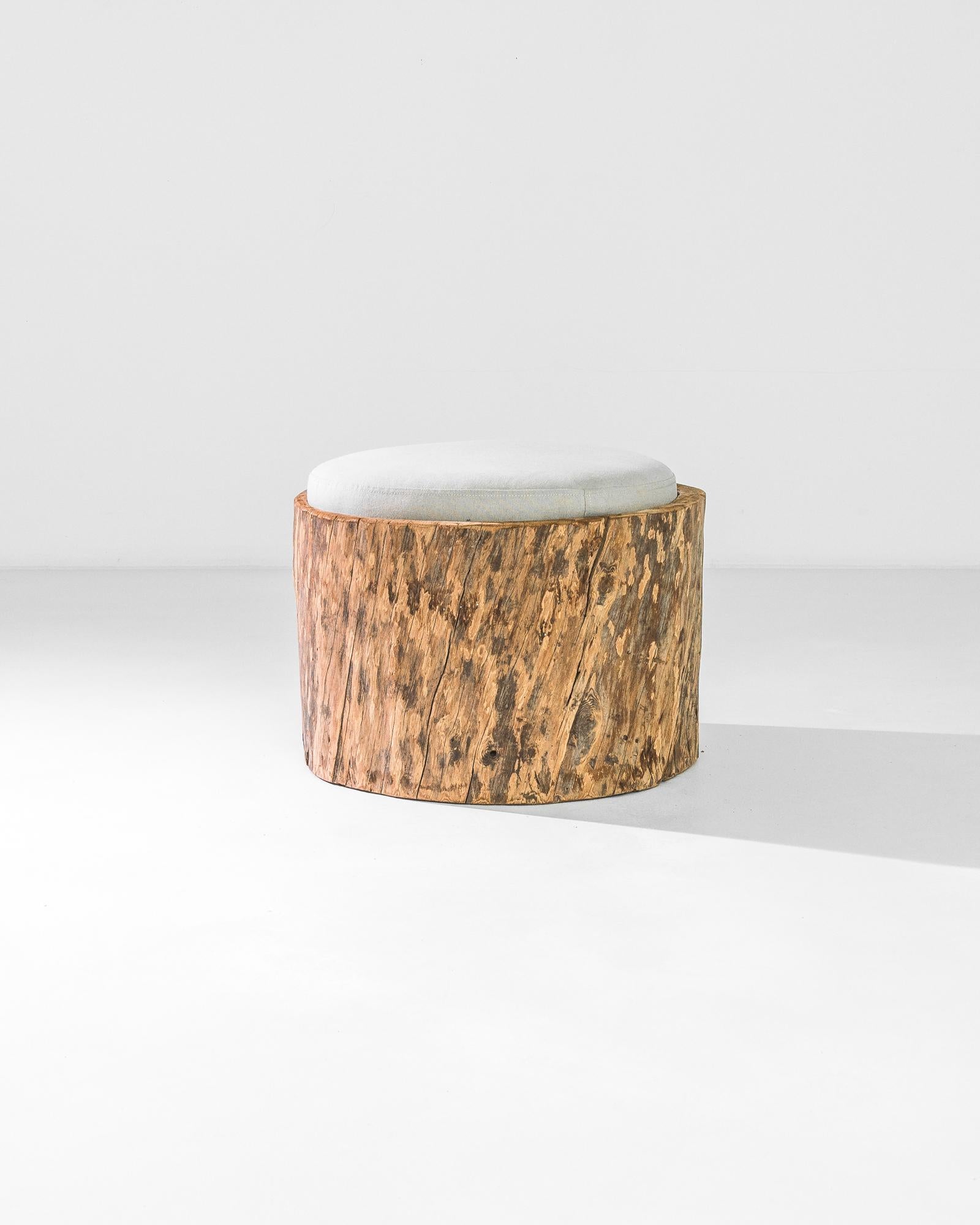 Carved out of a tree trunk circa 1800 and freshly upholstered, this original Polish pouf - is modern and rustic, a fresh combination of new and antique. The coarse texture of the wood is accompanied by softness. A newly upholstered fabric cushion,