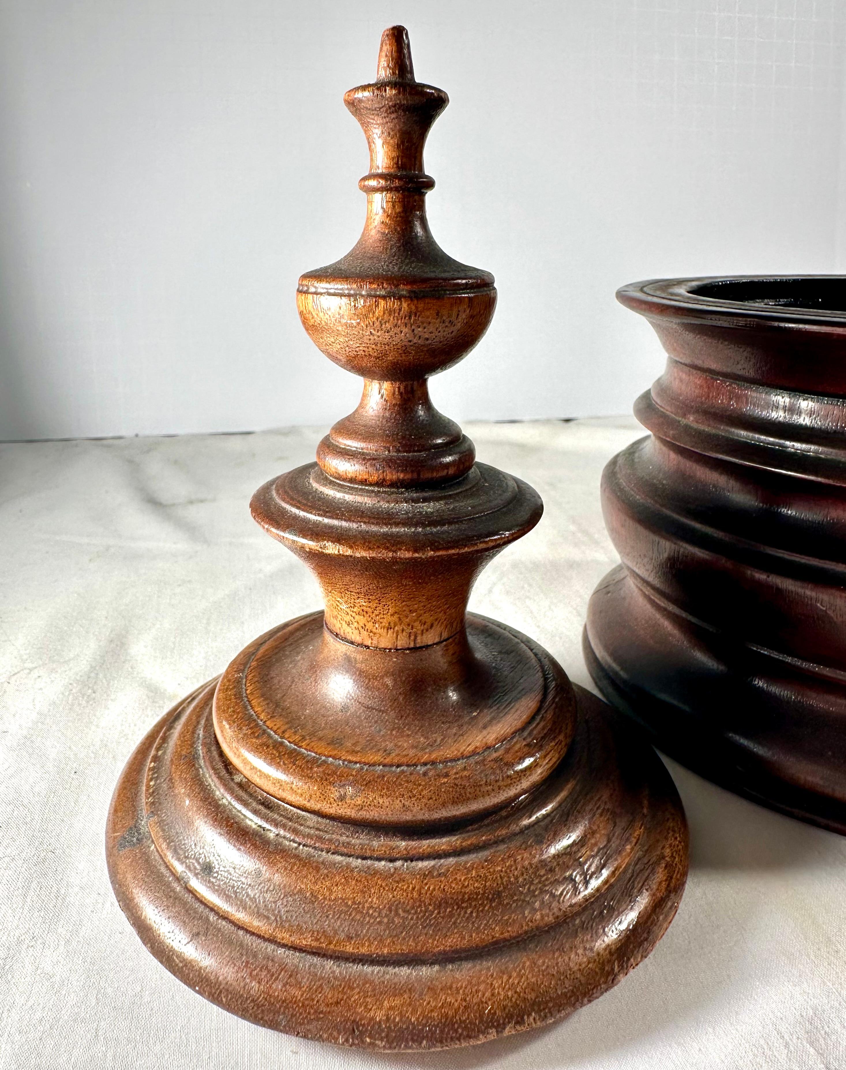 Antique Treen 19th Century Mahogany Tobacco Jar.

Antique Georgian Dutch tobacco jar is a good example of the fine craftsmanship of the Dutch, .  who became known for such beautiful jars.  The circa 1880s jar has a ring turned mahogany stepped body