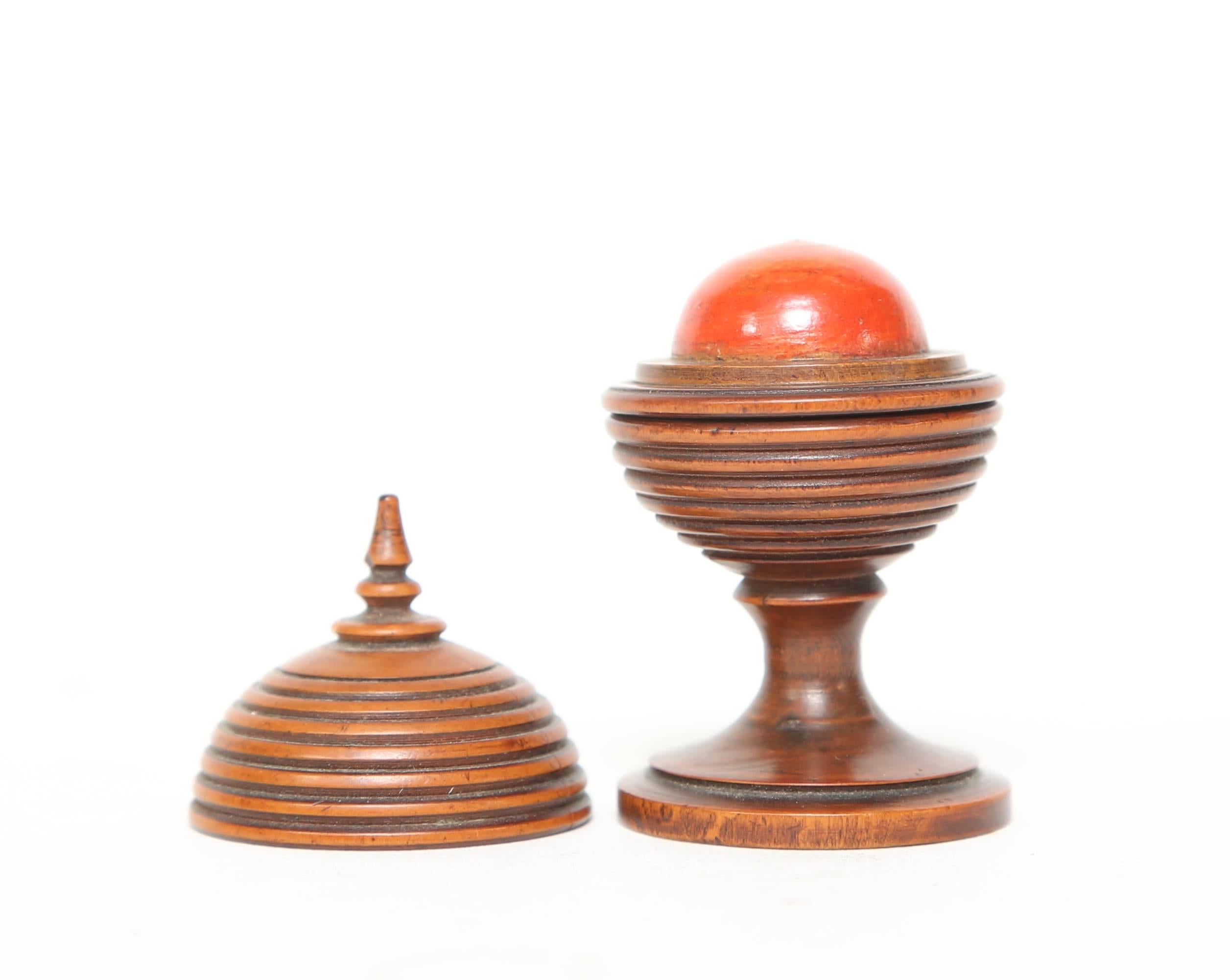 Antique boxwood magic trick with a disappearing red ball. Treen pieces are wooden objects sometimes lathe turned. This piece is beautifully crafted with great patina. After opening the game the first time by applying slight pressure you are able to