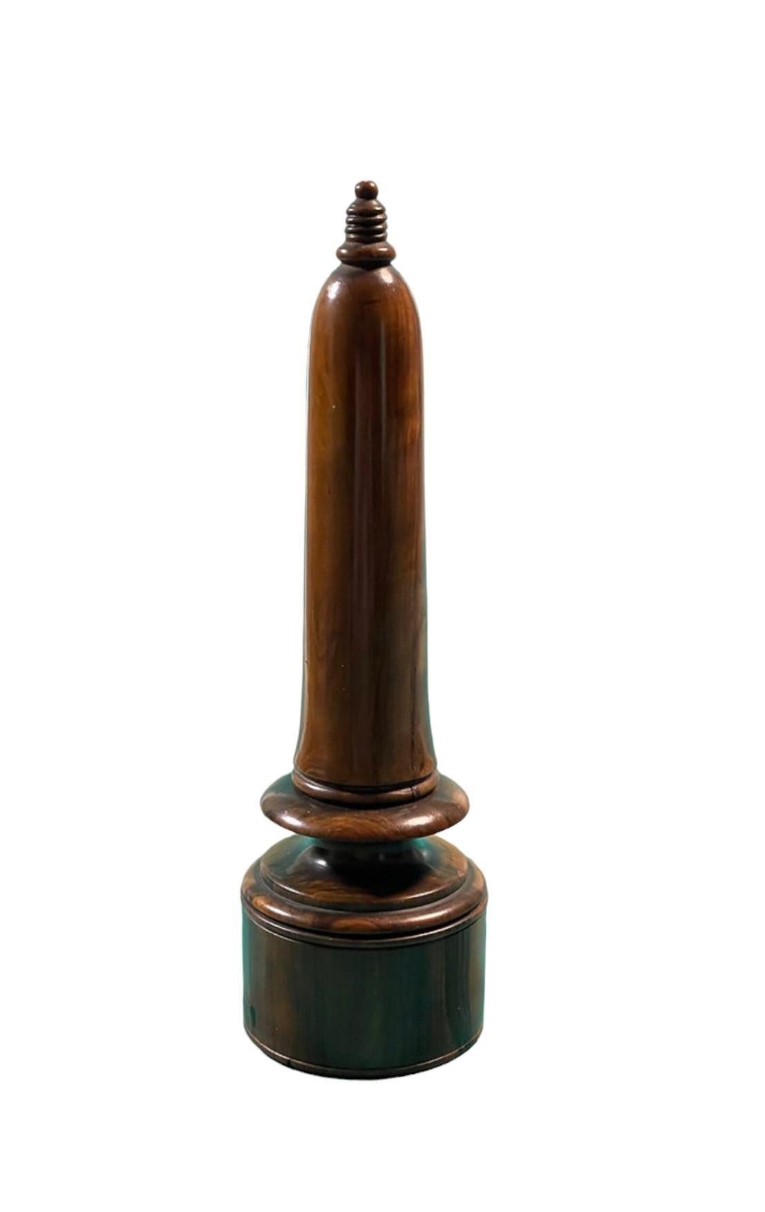 A rare and ingenious olivewood travelling candlestick holder with a compartment for the striker. The cover holds the candle in place, when unscrewed it acts as the handle. Beneath the candleholder is a compartment for the striker.