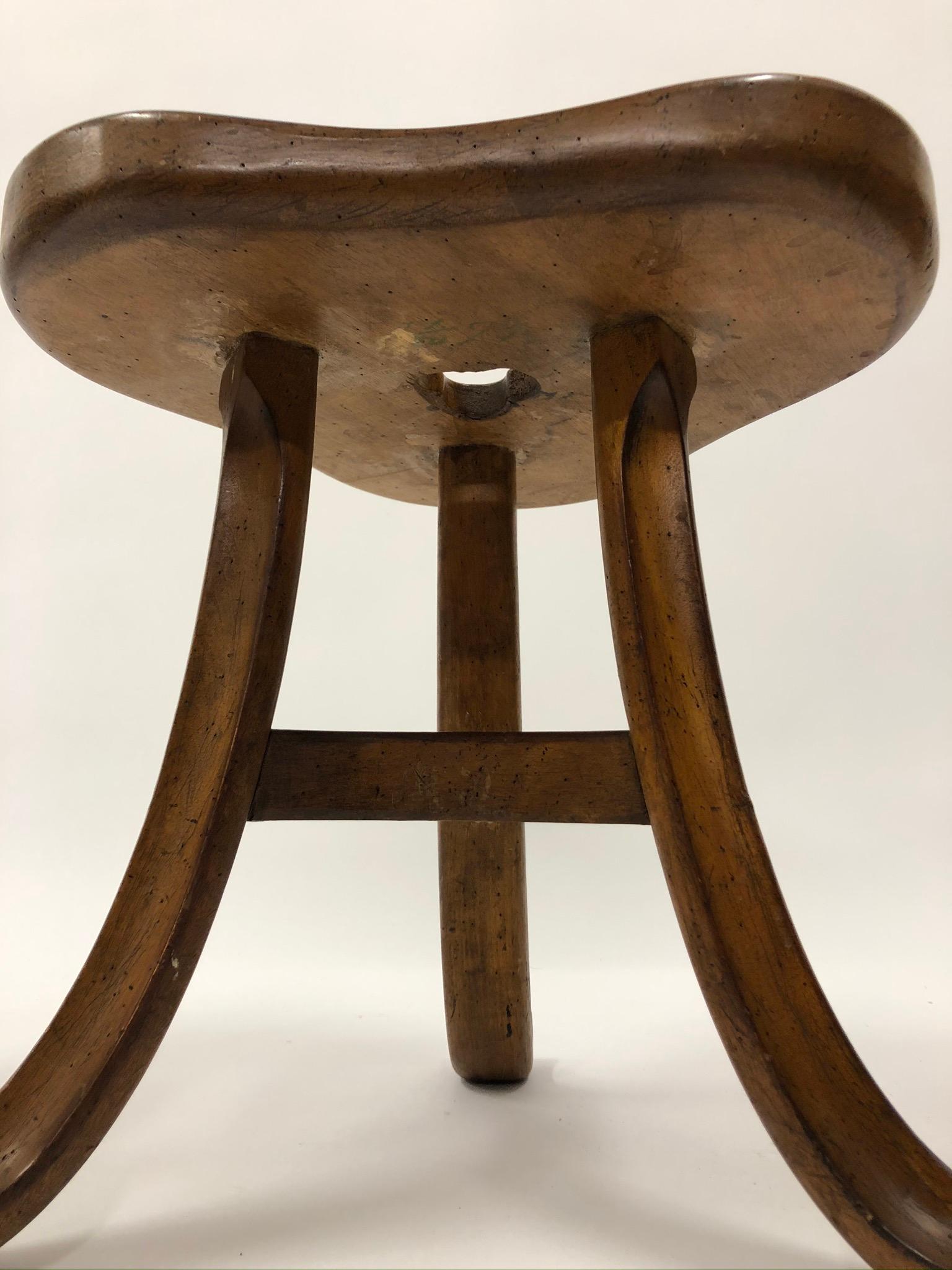 Antique trefoil top mounted stool on three splayed legs around one triangular shelf in an ale finish.

Property from esteemed interior designer Juan Montoya. Juan Montoya is one of the most acclaimed and prolific interior designers in the world