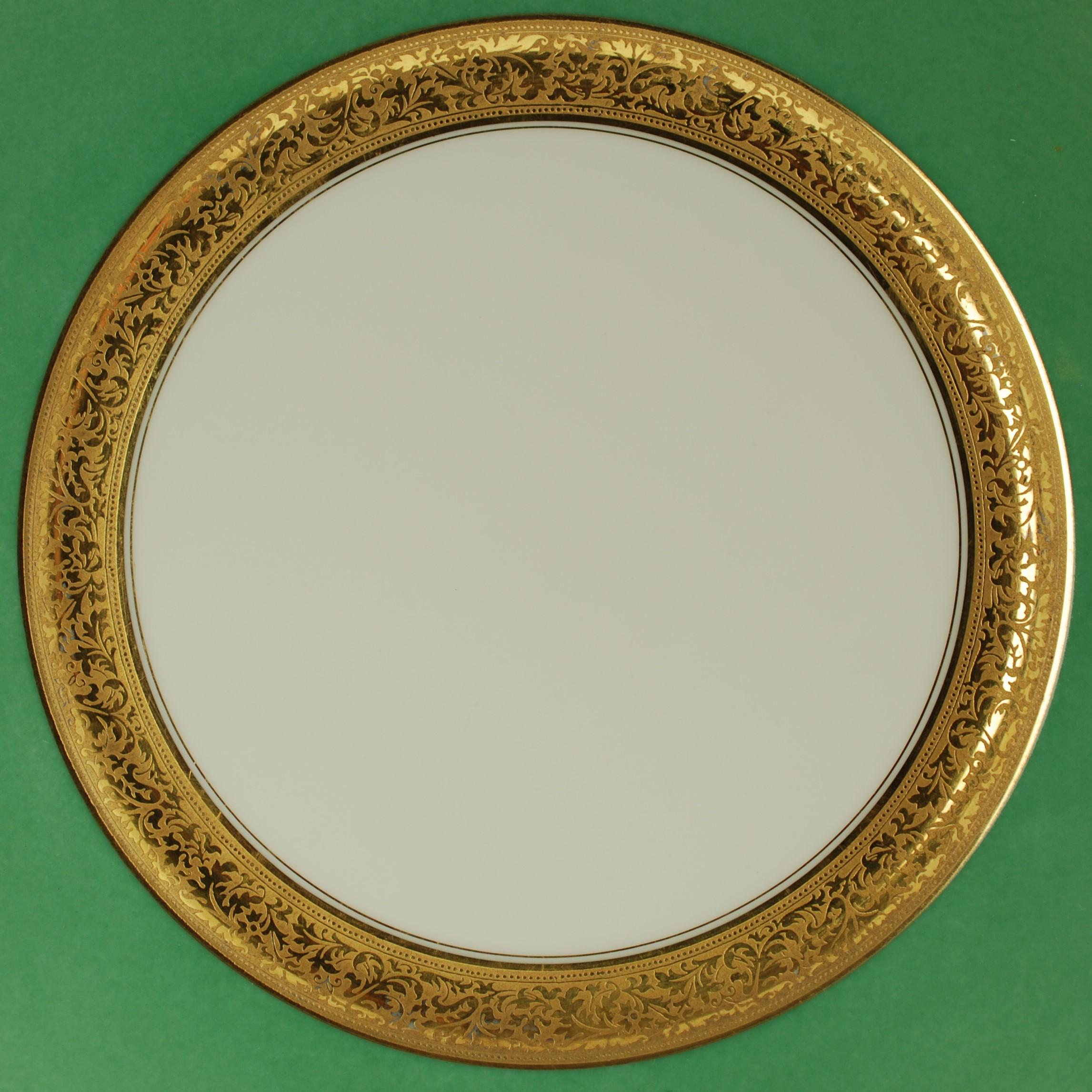 These late 19th century Limoges porcelain dinner plates were made and decorated by highly regarded French porcelain manufactory Tressemanes & Vogt. The shoulders of the plates feature jade green glaze bordered at the inside with a .75