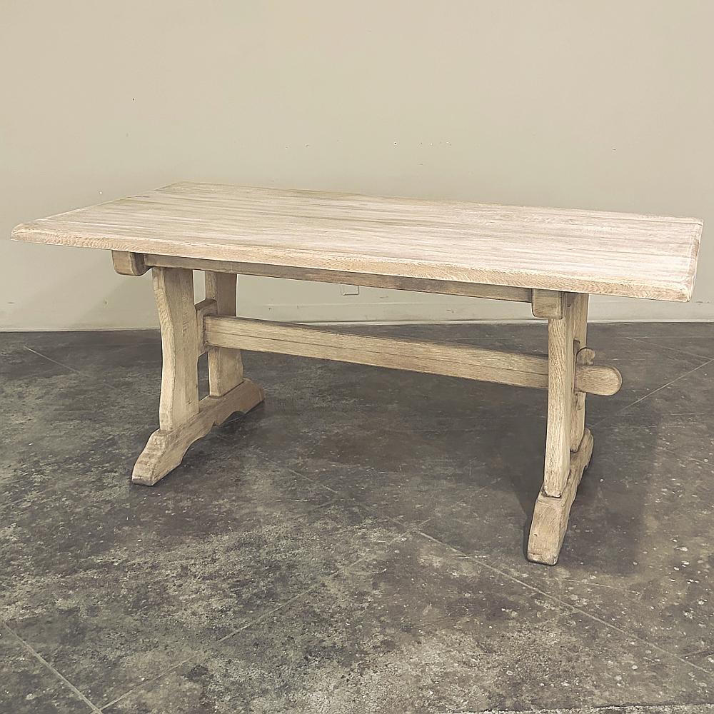Antique Trestle Dining Table in Stripped Oak is a timeless expression of a classic design that dates back centuries!  Crafted from thick planks of dense white oak, it features a trestle connecting the support structures created in an 
