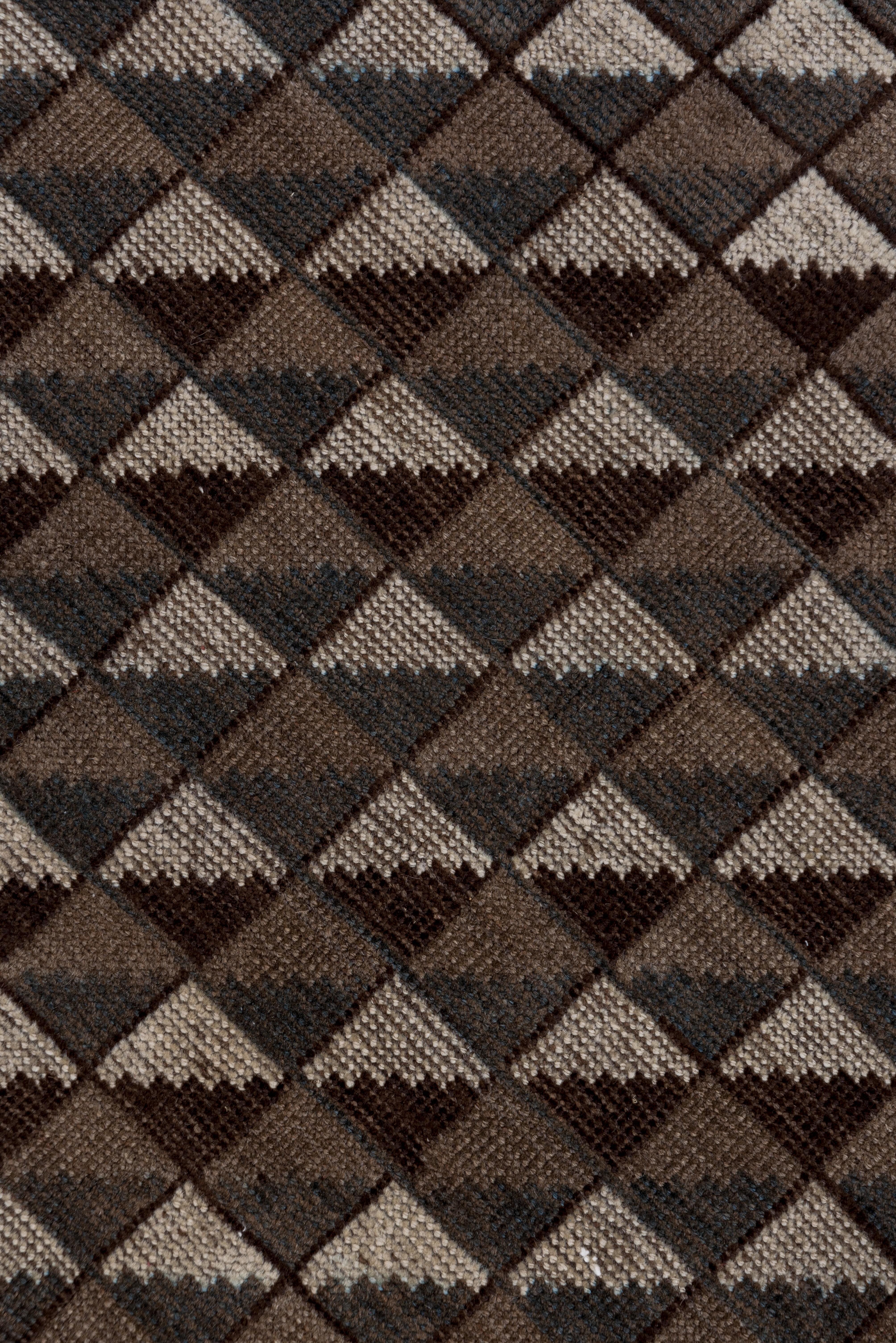 This Central Asian tribal carpet shows a triangle mosaic pattern in old ivory and brown tones within a very narrow flip-flop undulating vine and profile palmette border.