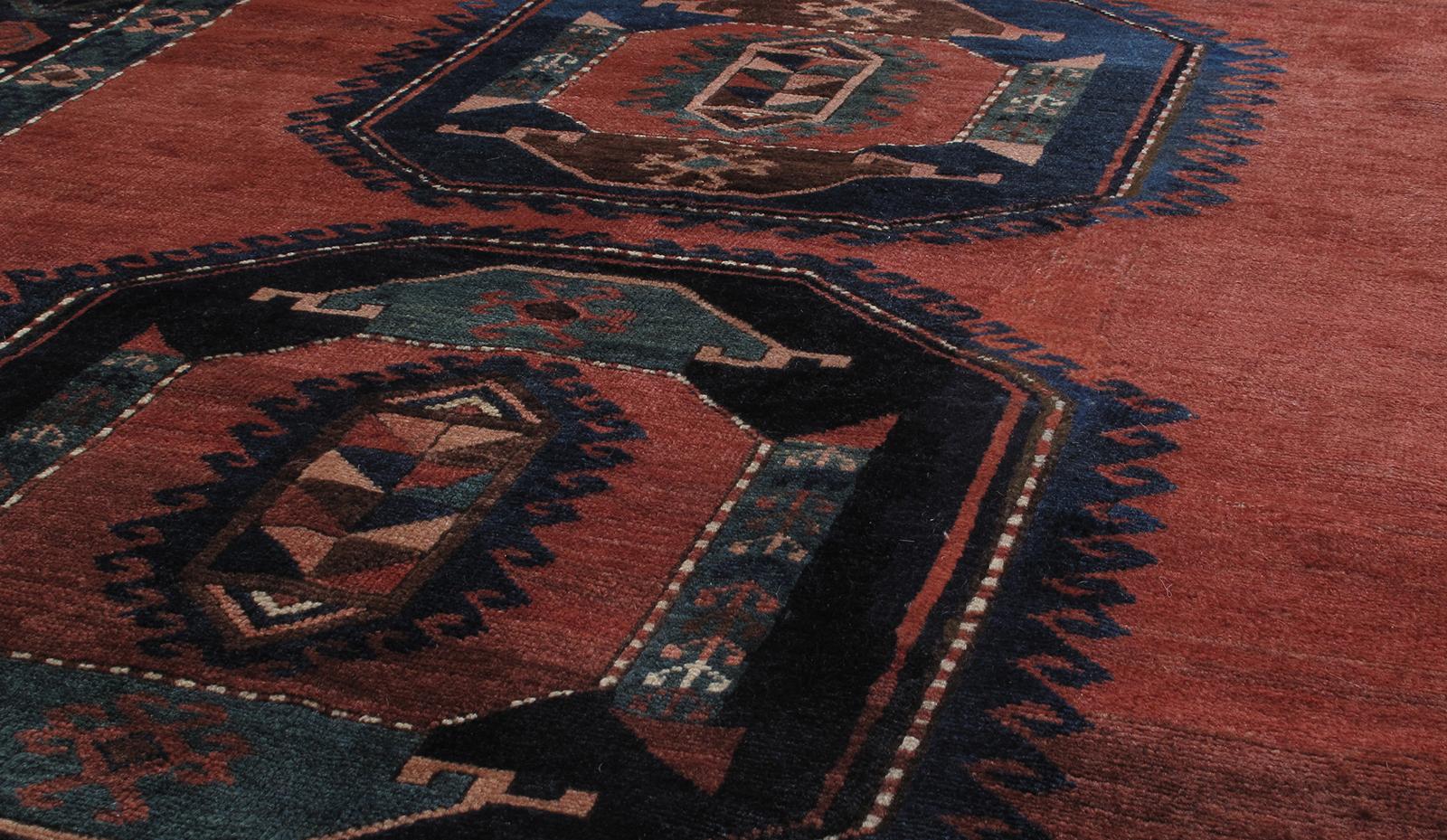 This antique Caucasian tribal rug is from Azerbaijan, a country located in the south Caucasus region. It is constructed of 100% handspun wool and natural dyes. This rug features a bold, articulated geometric pattern, which is a very distinctive