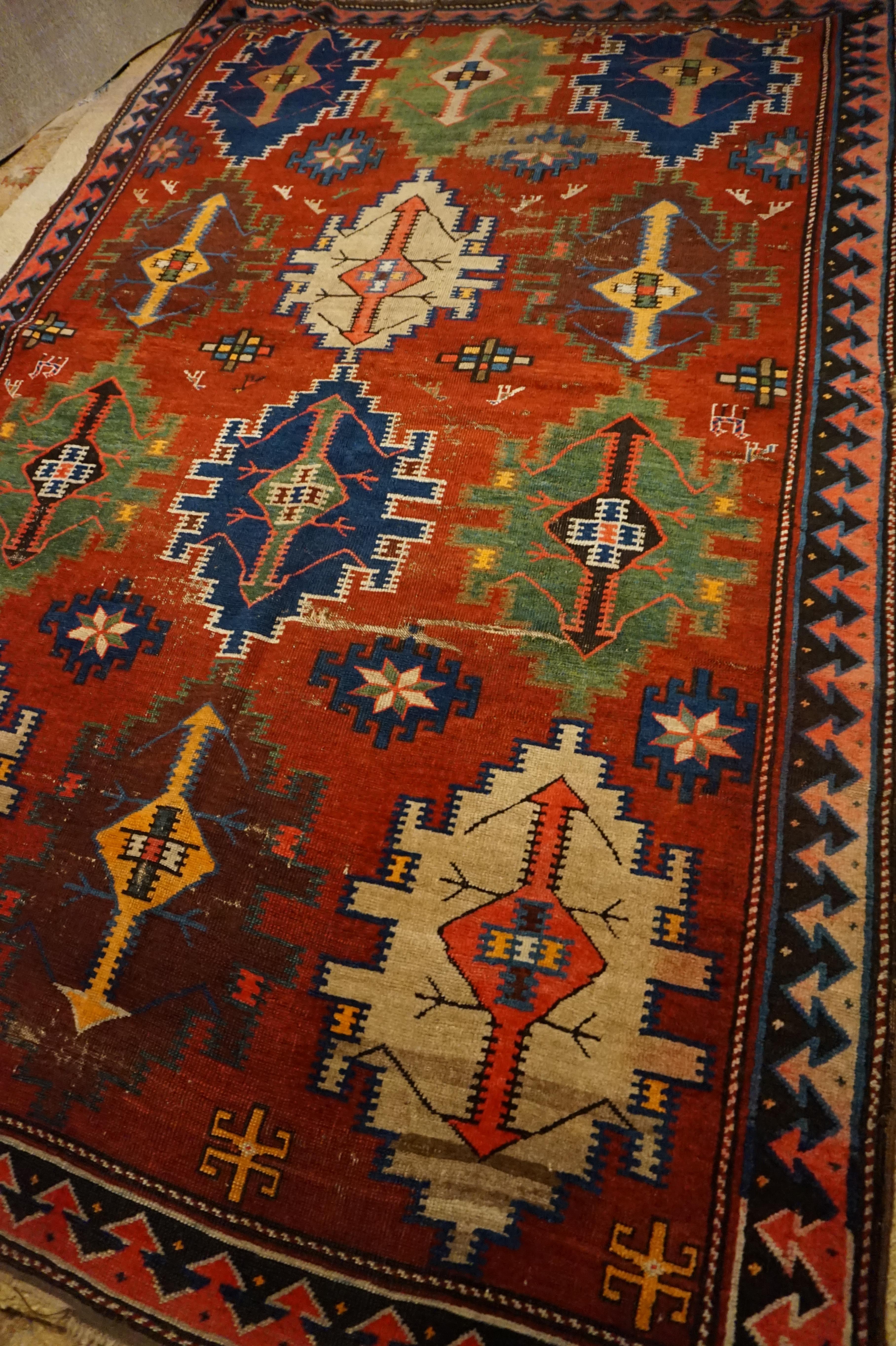 Vivid hues in natural dues and medallions that appear to be hanging lamps. This rug exudes great warmth. Woven in natural dues. Some low pile areas as shown and minor fringe wear but in overall good condition with lots of life to offer,

circa