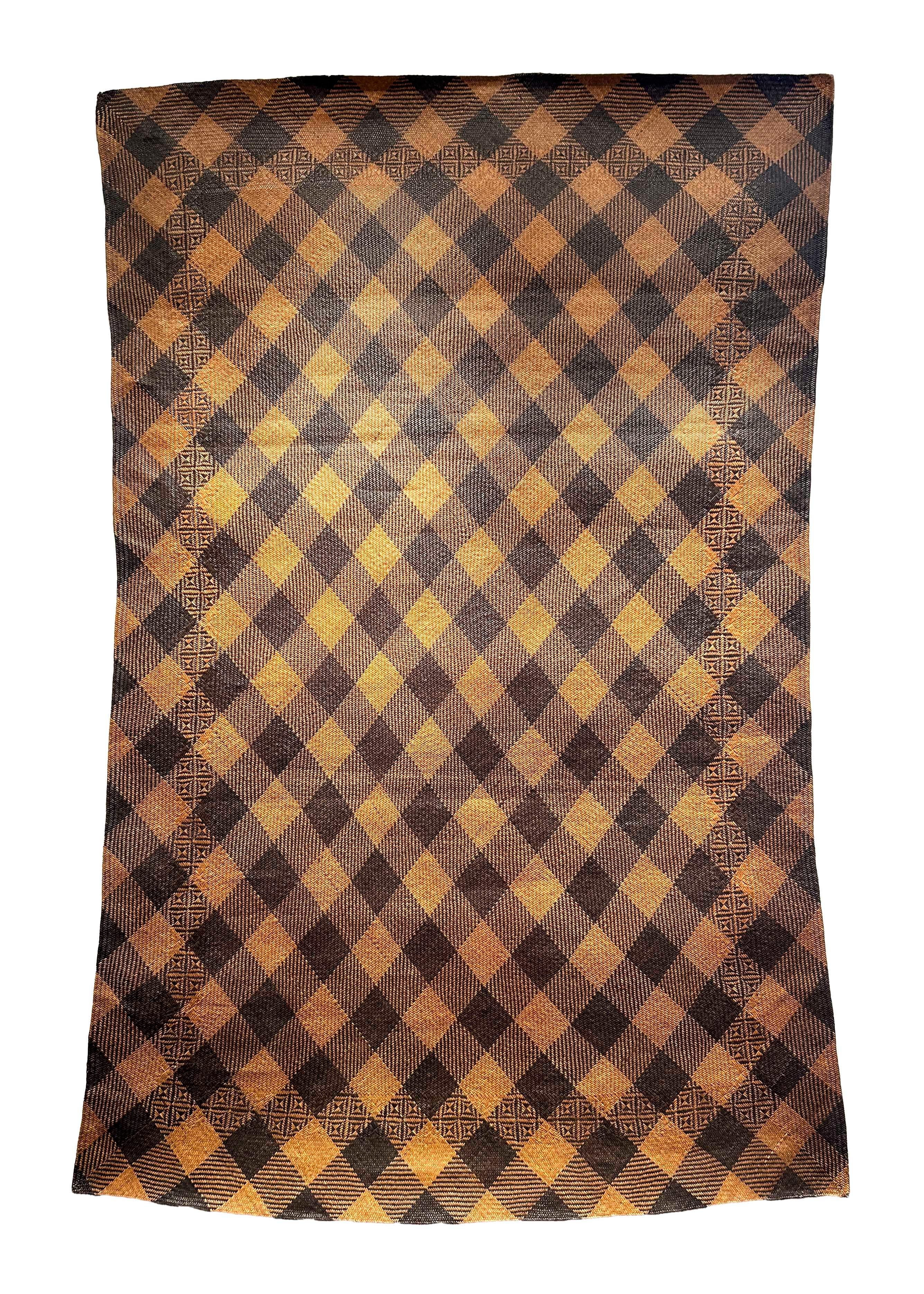 Antique Tribal Dayak Plaited Rattan Longhouse Mat (Tikar), Kalimantan

The tightly woven longhouse sleeping mats of Kalimantan are almost exclusively constructed by women, who begin their rattan plait work from one corner and work outward until the