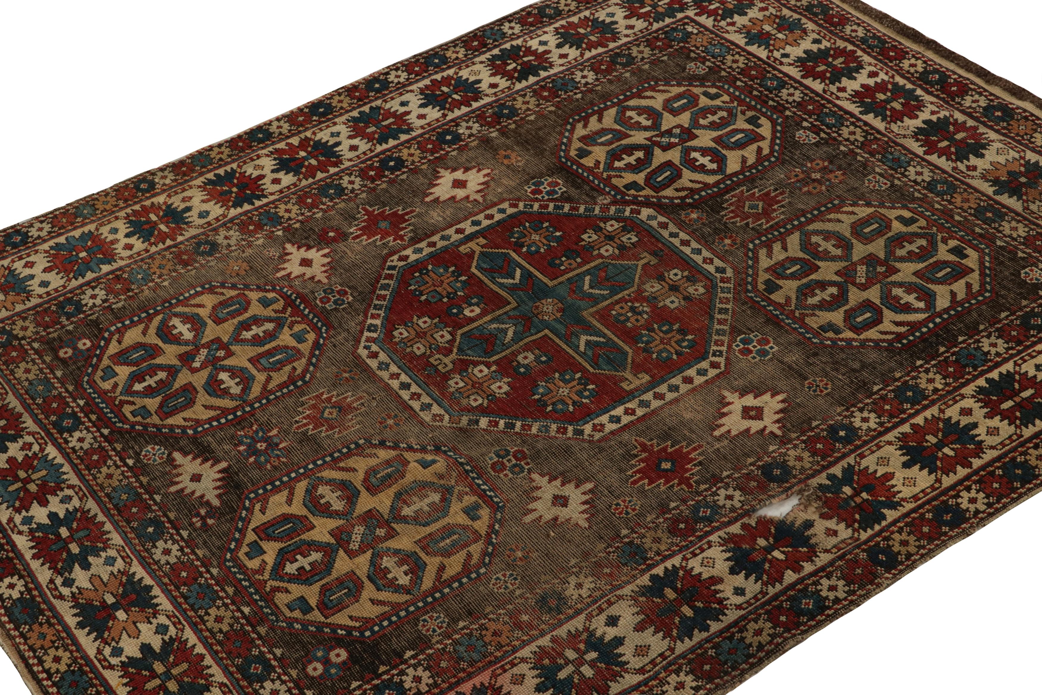 Hand-knotted in wool, this 4x5 Antique tribal Kazak rug is believed to originate from turn-of-the-century Russia. An exciting new curation from Rug & Kilim, its design favors a primitivist style with large geometric patterns in red, blue and