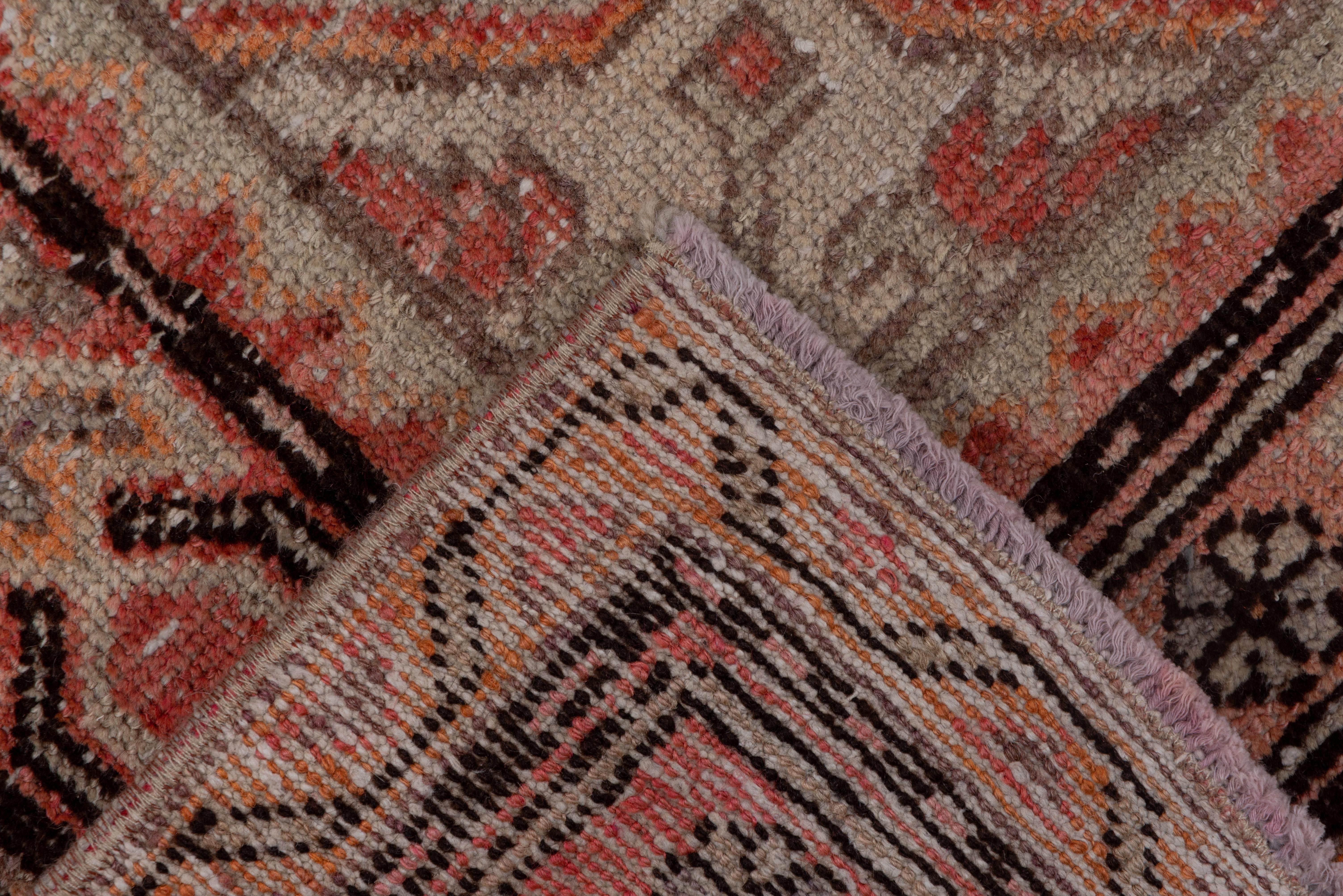 Wool Antique Tribal Khotan Rug, Pink Red Orange and Light Blue Palette Unusual Design For Sale