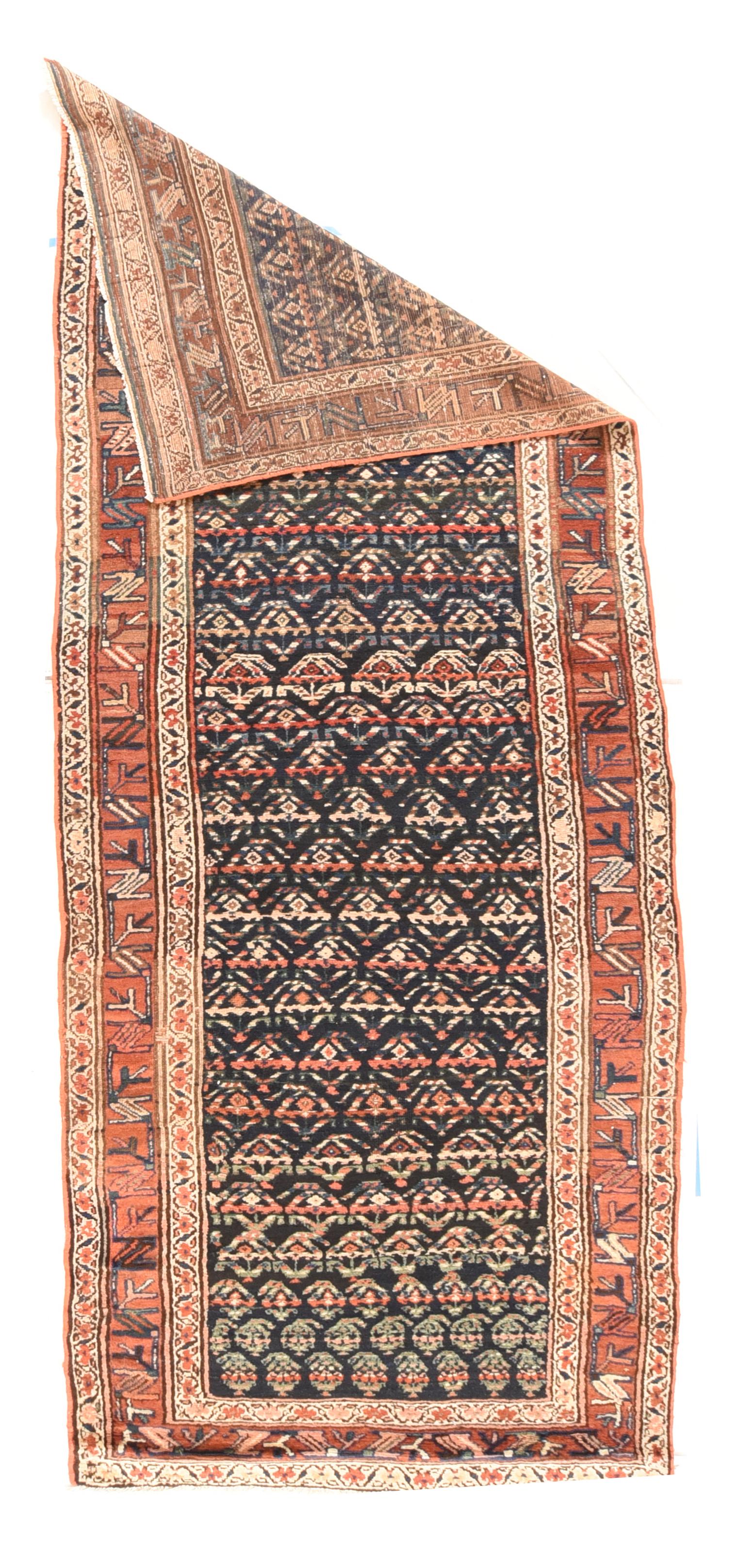 Antique Tribal N.W Persian Rug 3'8'' x 11'. The row-reversing botehs grow in size while decreasing in number on the dark blue indigo field, with accents in: rust-rose, sand, red and green. The botehs are arrayed in close, half-drop, offset rows with