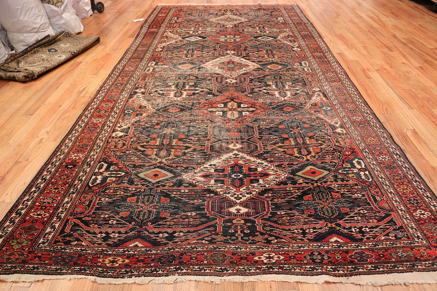 Extremely fine Tribal Persian Bakhtiari antique shabby Chic rug, country of origin or rug type: Persian rug, circa late 19th century. Size: 7 ft x 14 ft 3 in (2.13 m x 4.34 m)

This breathtaking and fine antique shabby Chic rug features a
