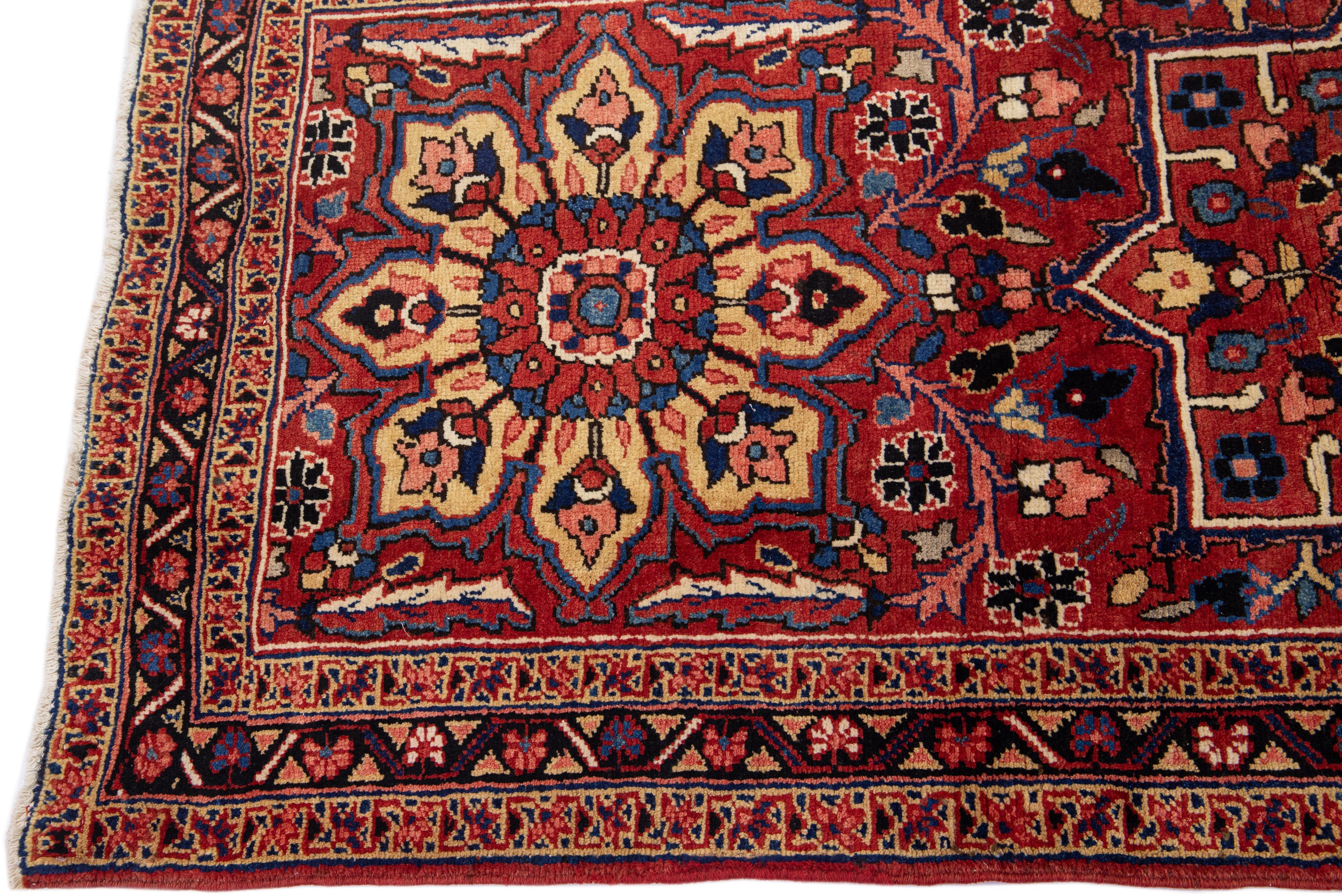 Beautiful antique Heriz hand-knotted wool rug with a red color field. This Persian rug has a designed frame and multicolor accents in a gorgeous Tribal design.

This rug measures: 3'8