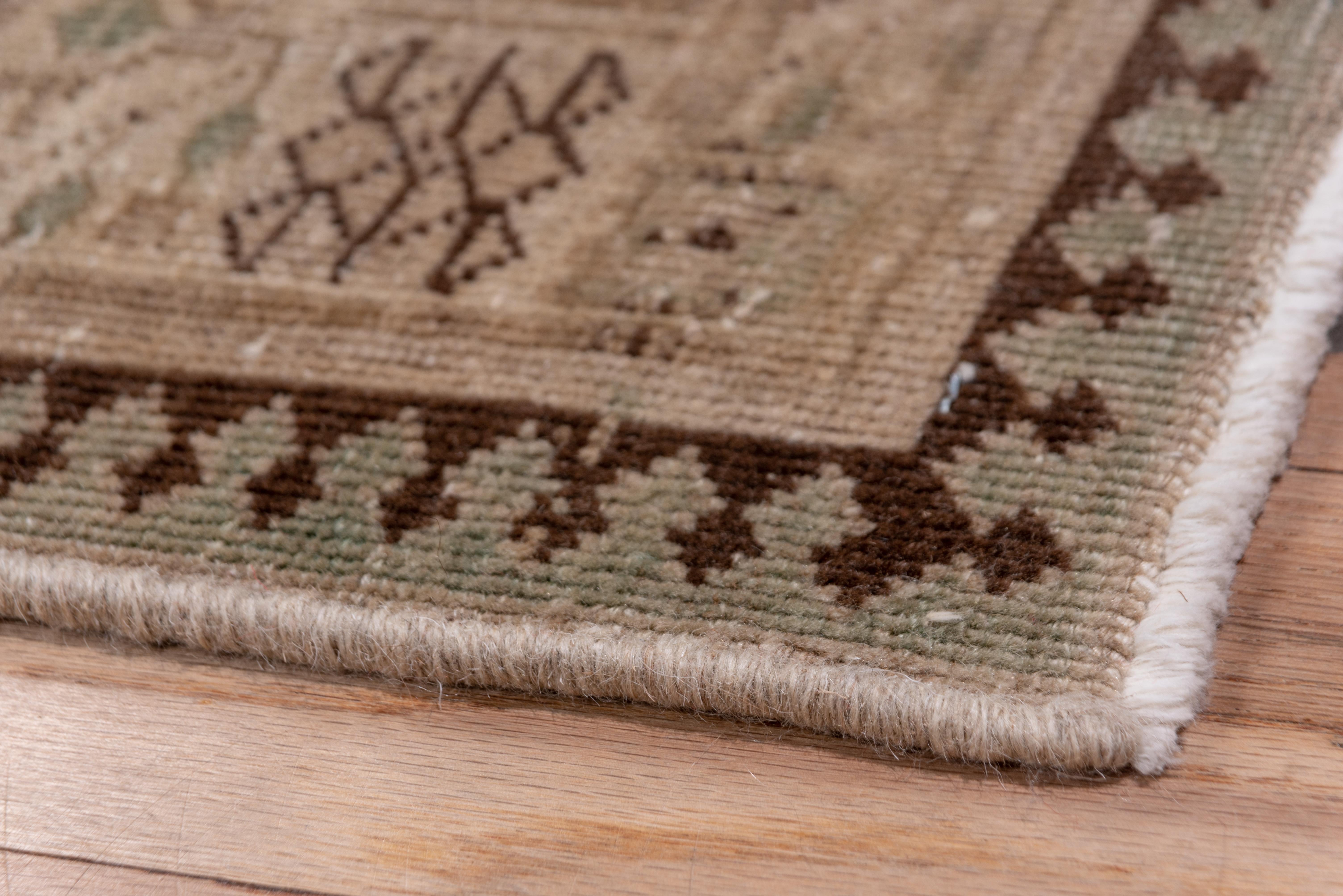A light brown NW Persian runner with a traditional geometric pattern of four cartouches on a pale camel-tone ground. Narrow main cream border of squared palmettes and squared floret arrays. Keyhole reciprocal outer stripe. Medium village weave.