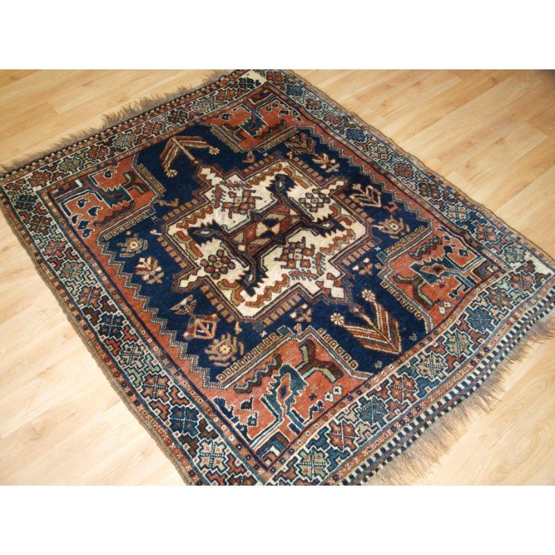 Antique tribal rug by the Luri tribe, the rug has a square central medallion in ivory on a deep indigo blue field; the field contains animals and other tribal designs.

The rug is of a very nice small size.

The rug is in good condition with slight
