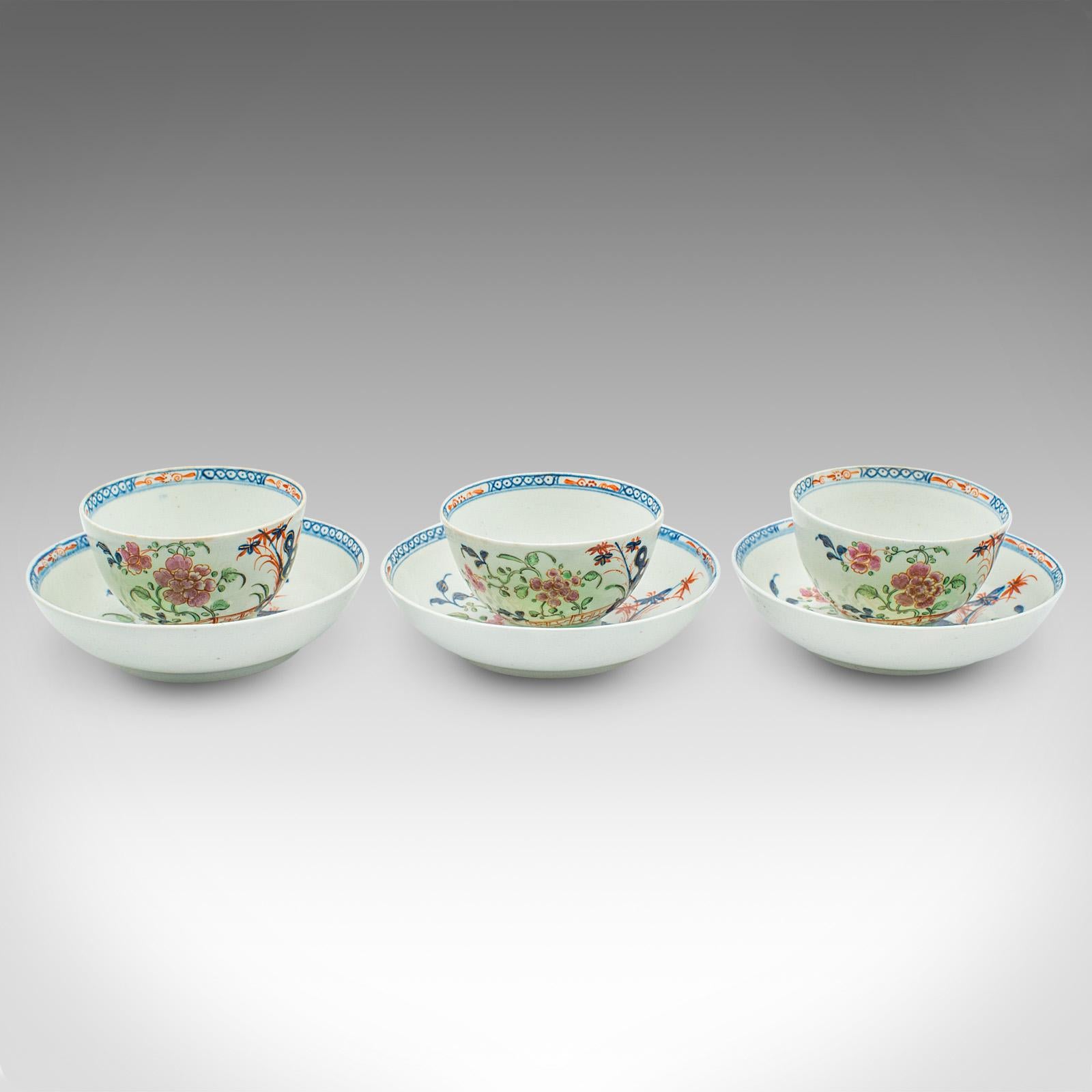 
This is a trio of small Oriental teacups. A Chinese, ceramic cup and saucer, dating to the late Victorian period, circa 1900.

Appealing hand painted cups, with a petite form
Displaying a desirable aged patina throughout
Ceramic presents a white