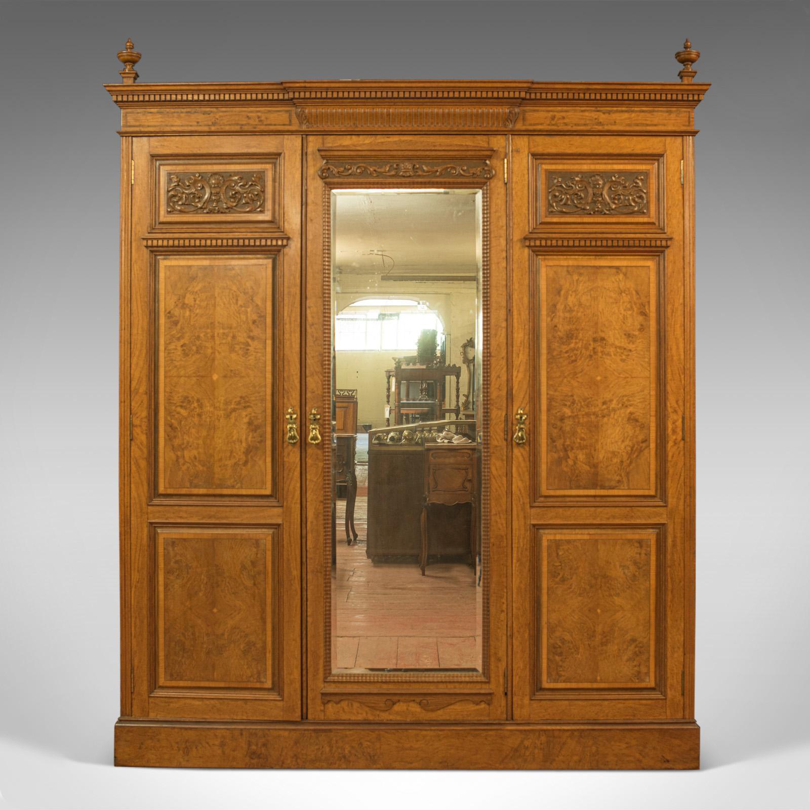 This is an antique triple wardrobe. A Scottish, oak and burr walnut compactum dating to the mid-Victorian period of the 19th century, circa 1870.

Superior cuts of oak and burr walnut enchant with rich caramel hues and fine grain